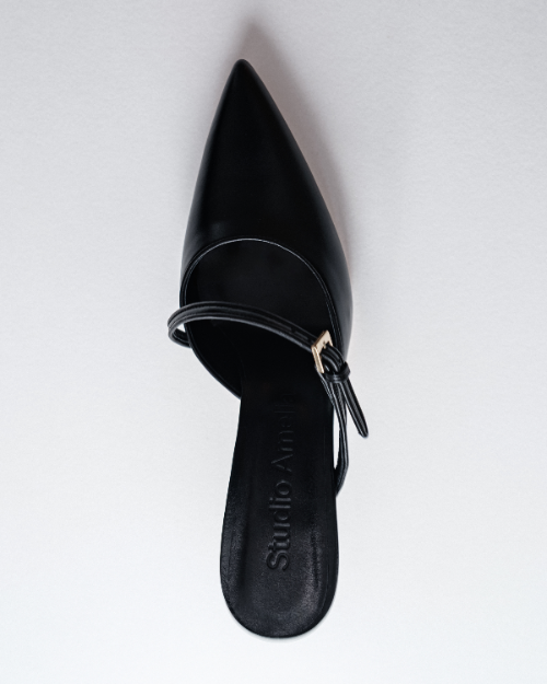 A pointed black leather heel with buckle