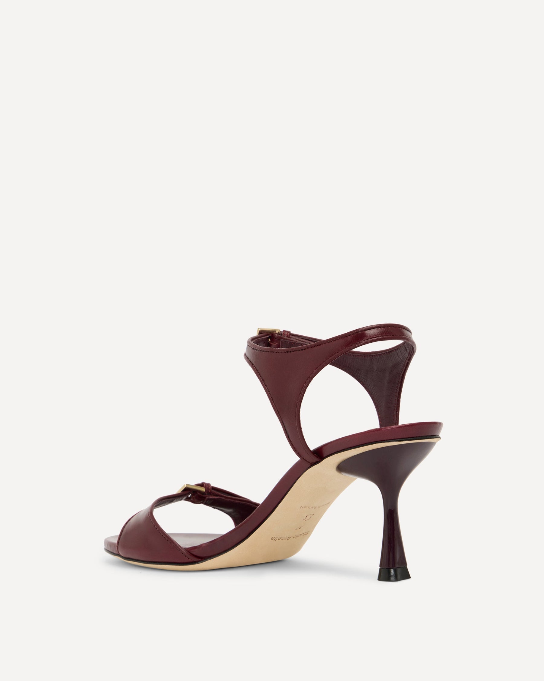 Maroon high-heeled sandal on a white background