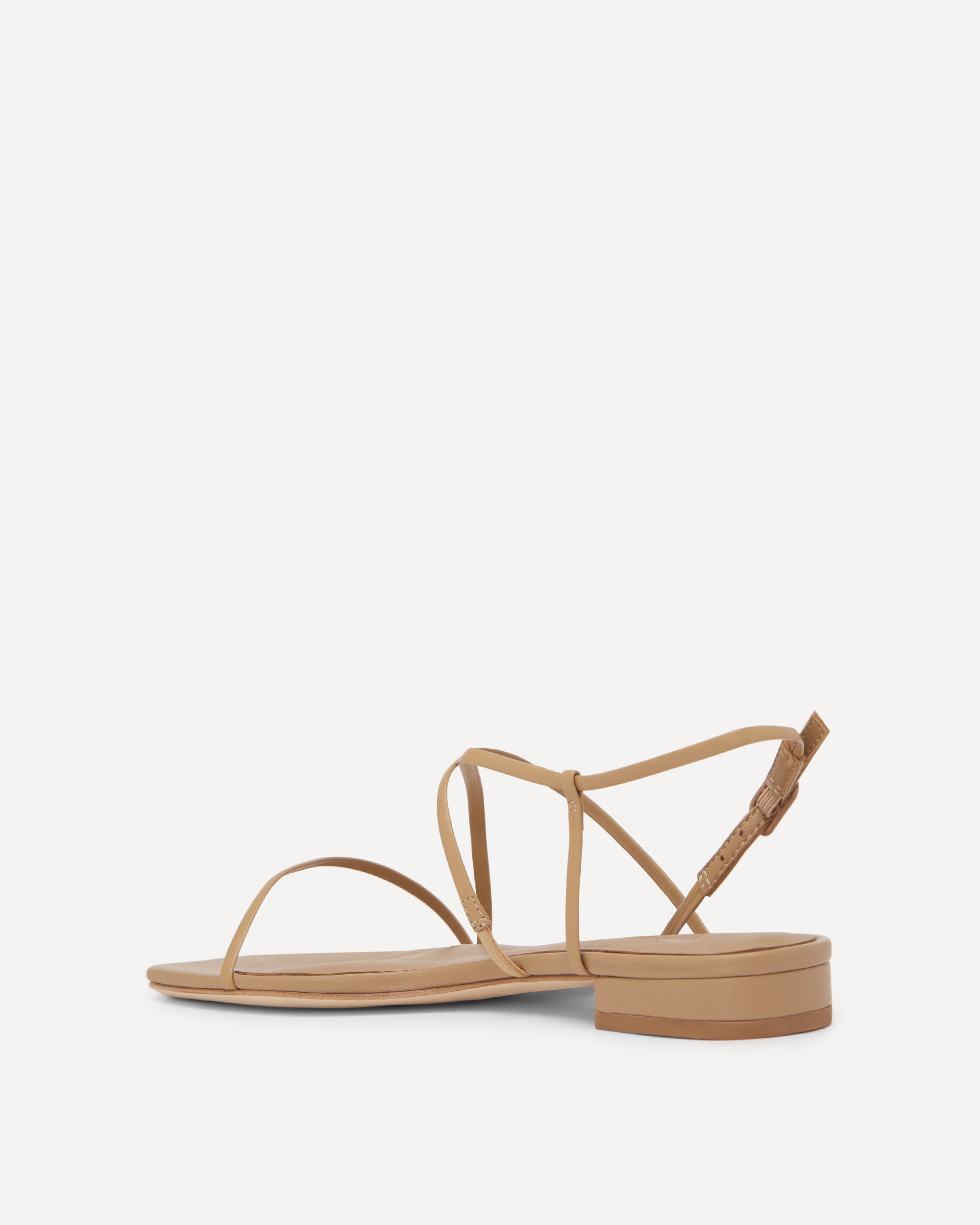 Beige sandal with thin straps on a white background