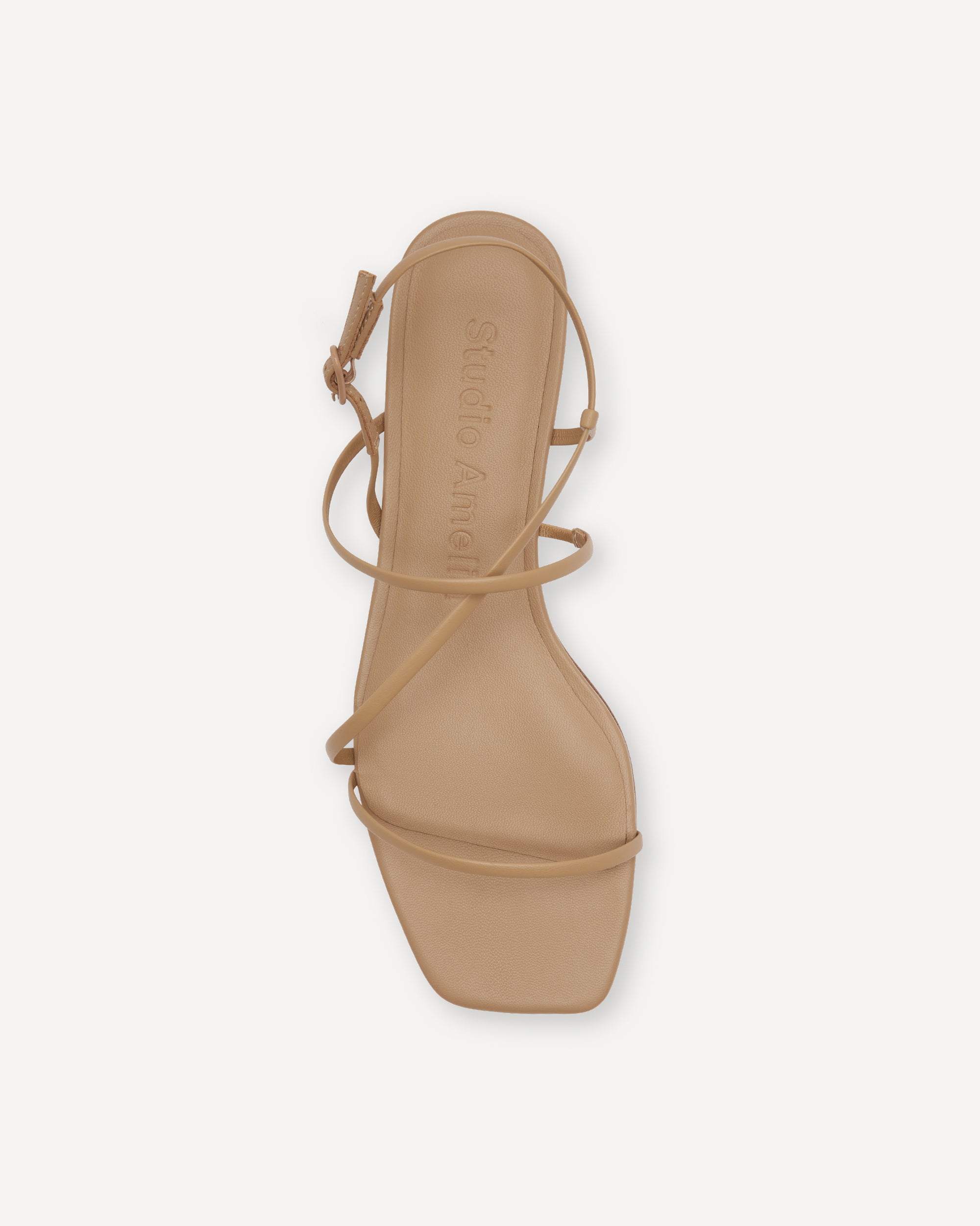 Beige sandal with thin straps on a white background