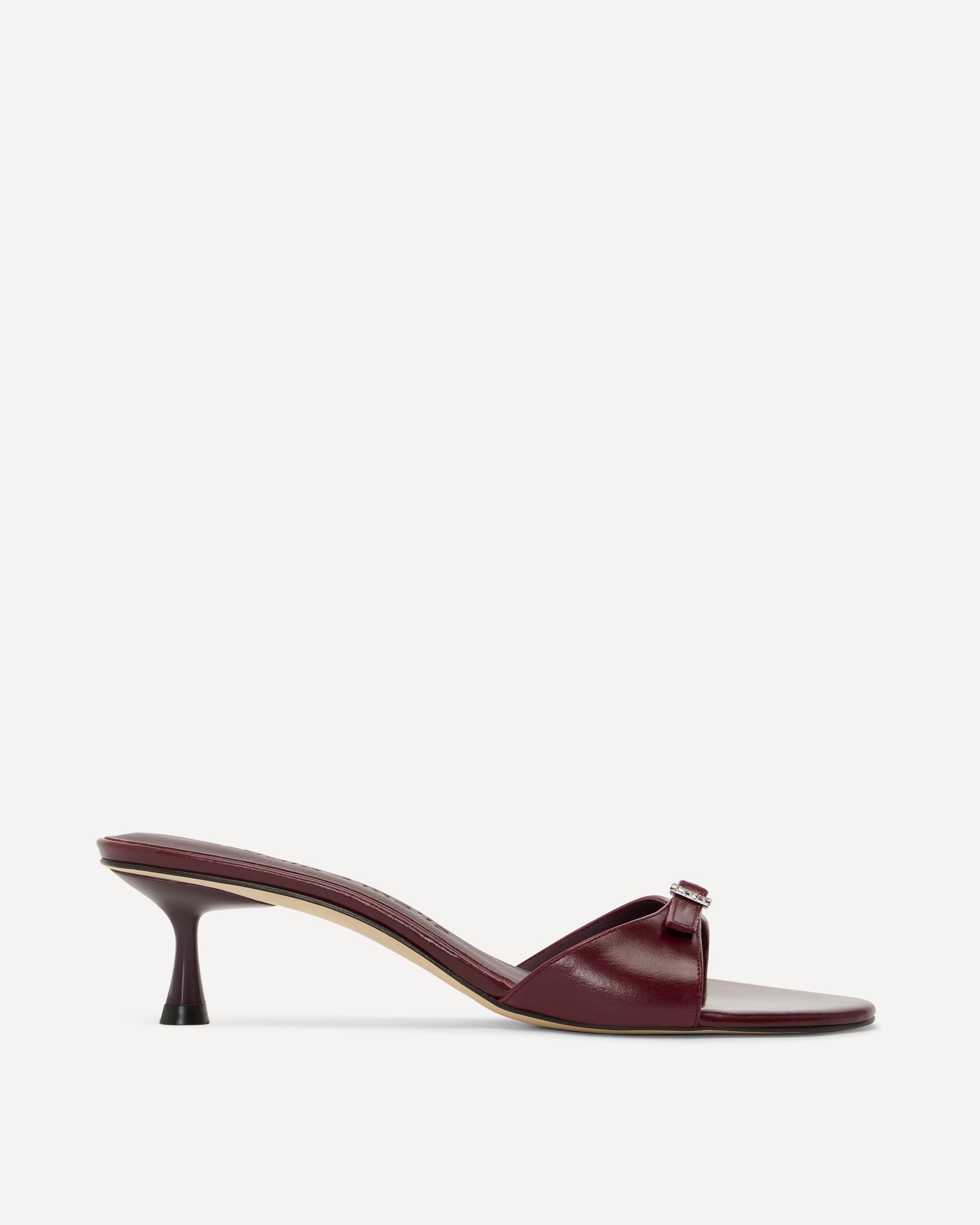 Burgundy sandal with a thin heel on a white background