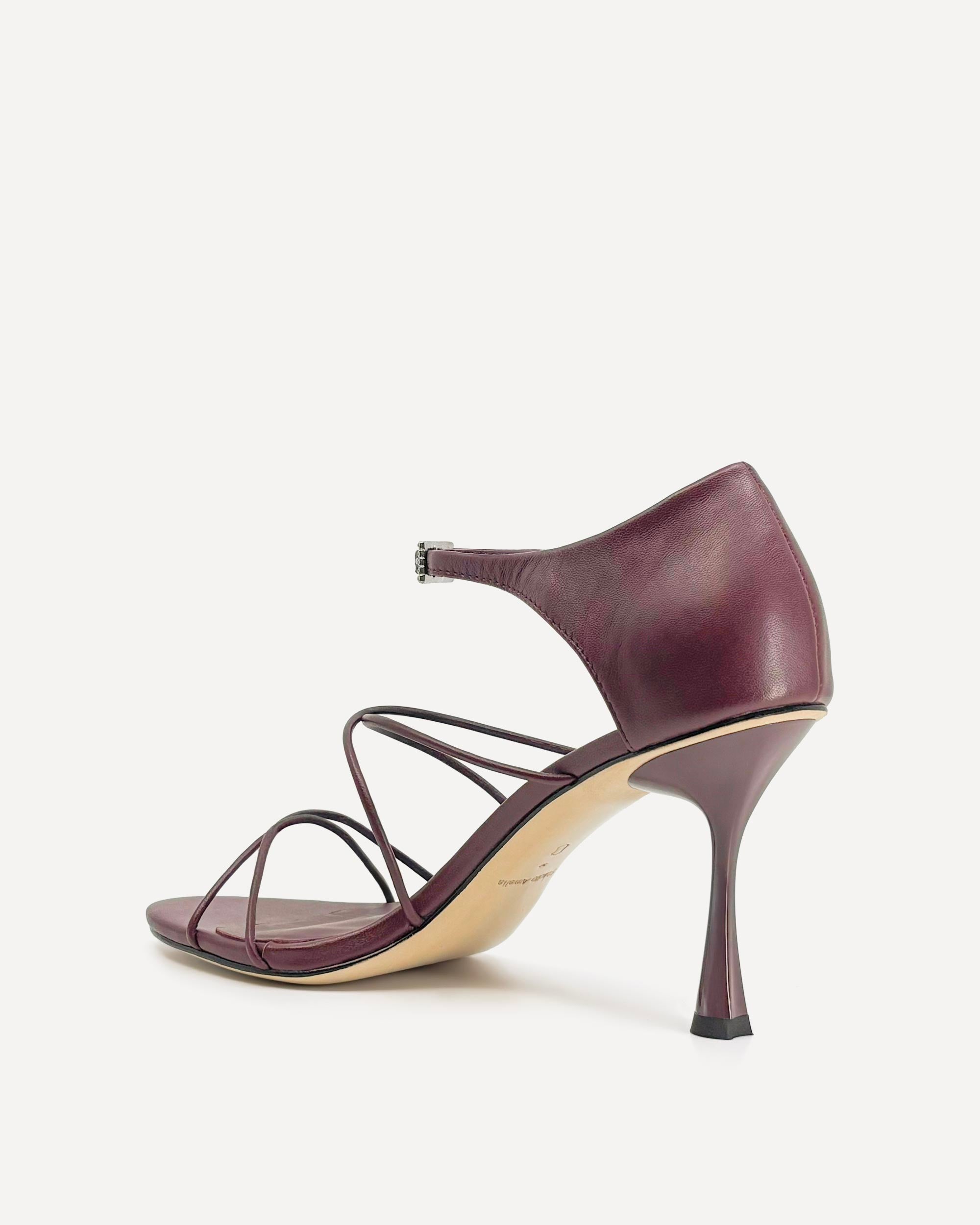 Purple high-heeled sandal on a white background