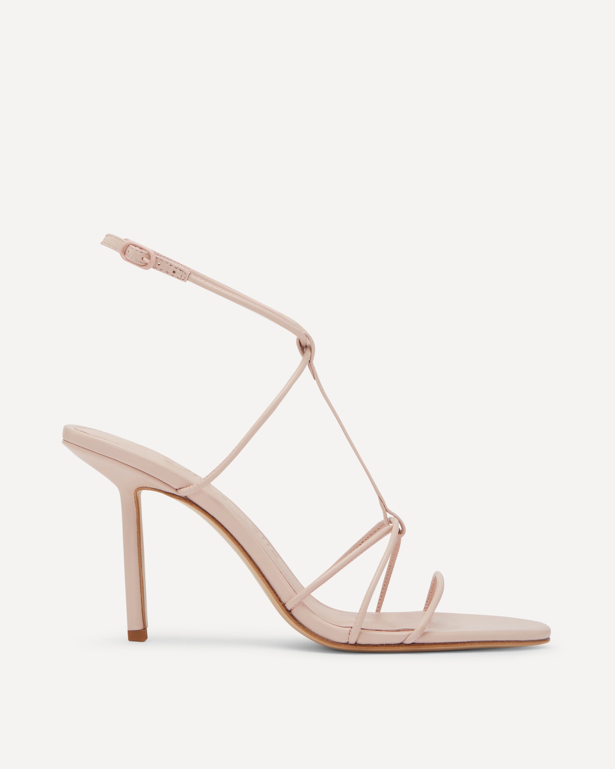 A pink strappy sandal with a high heel