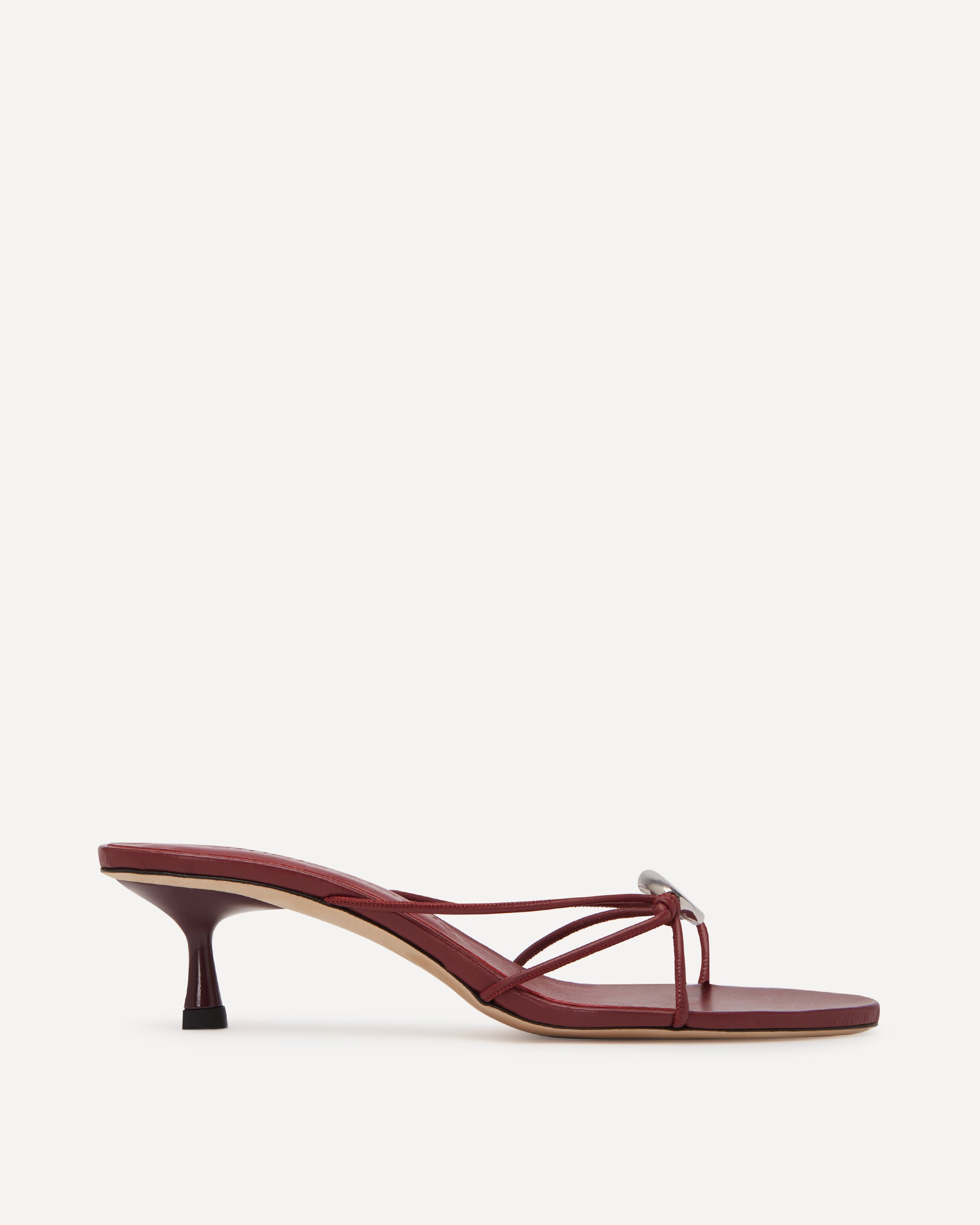 A maroon coloured leather sandal with a