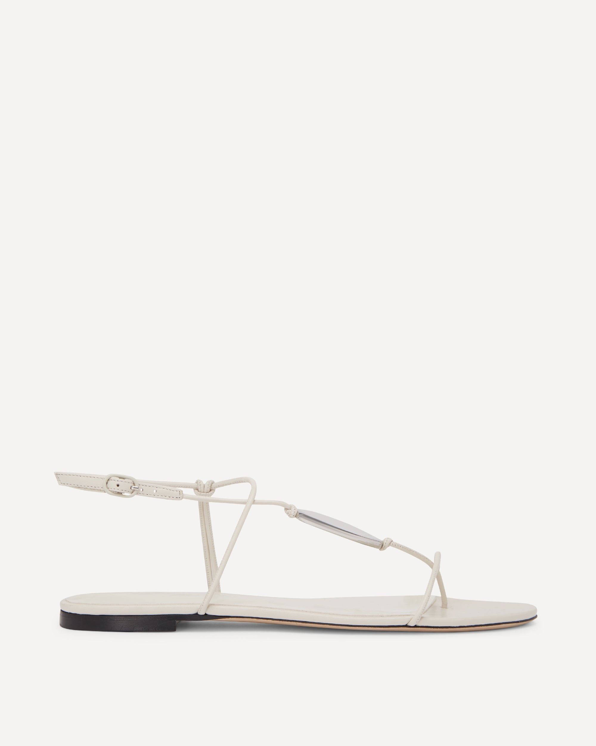 White sandal with thin straps on a white background