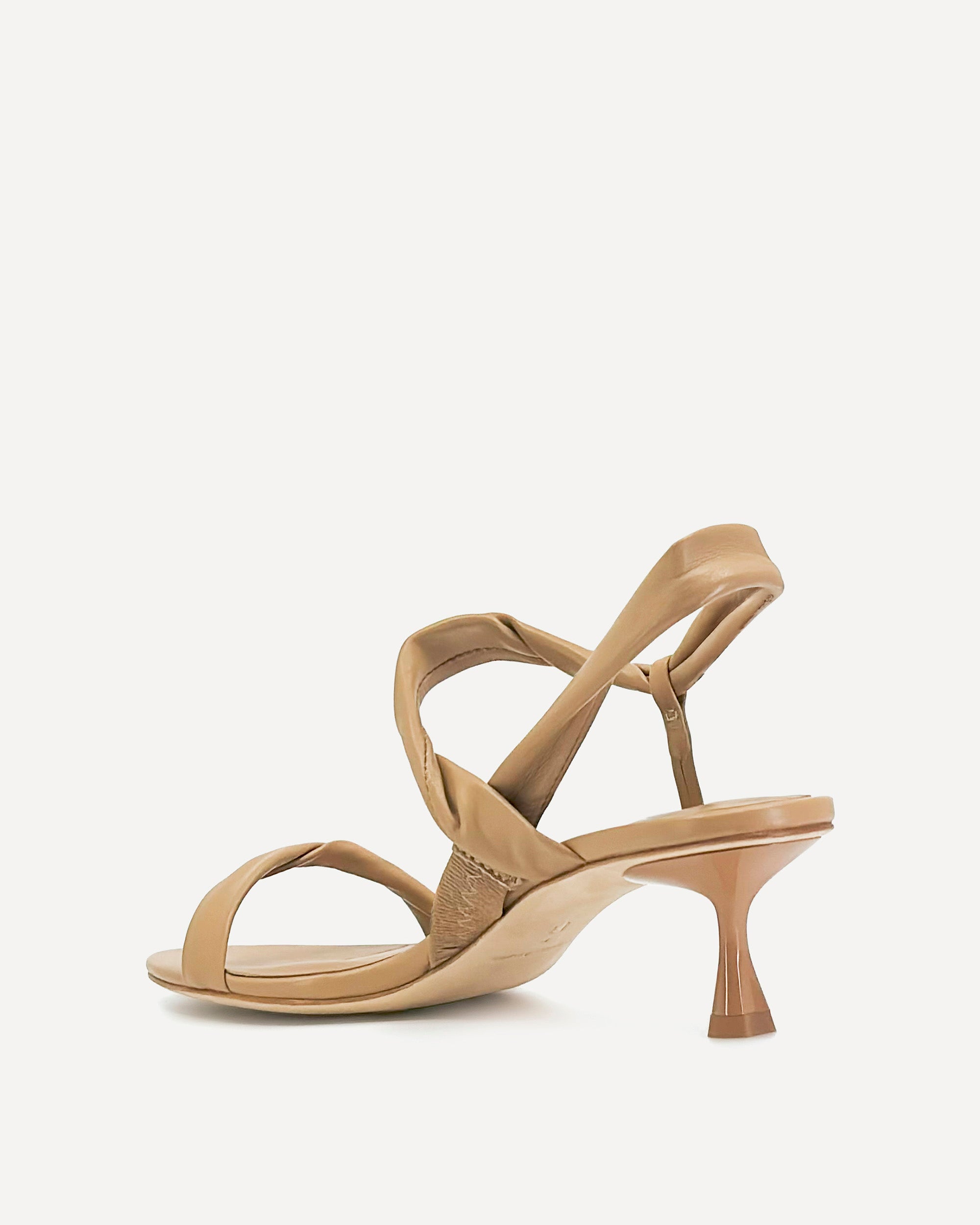 Beige sandal with criss-cross straps on a light gray background