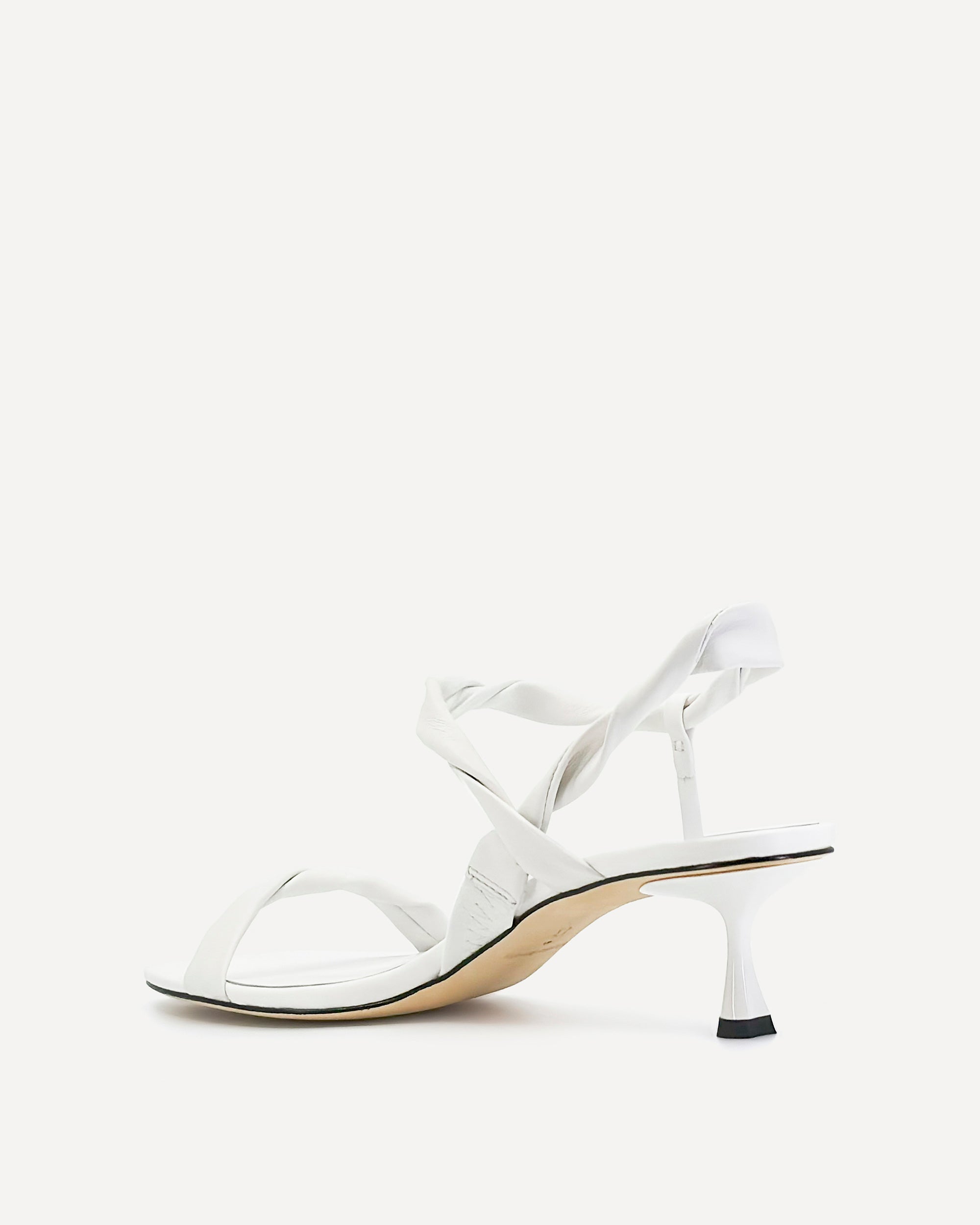 White sandal with thin strap on a white background