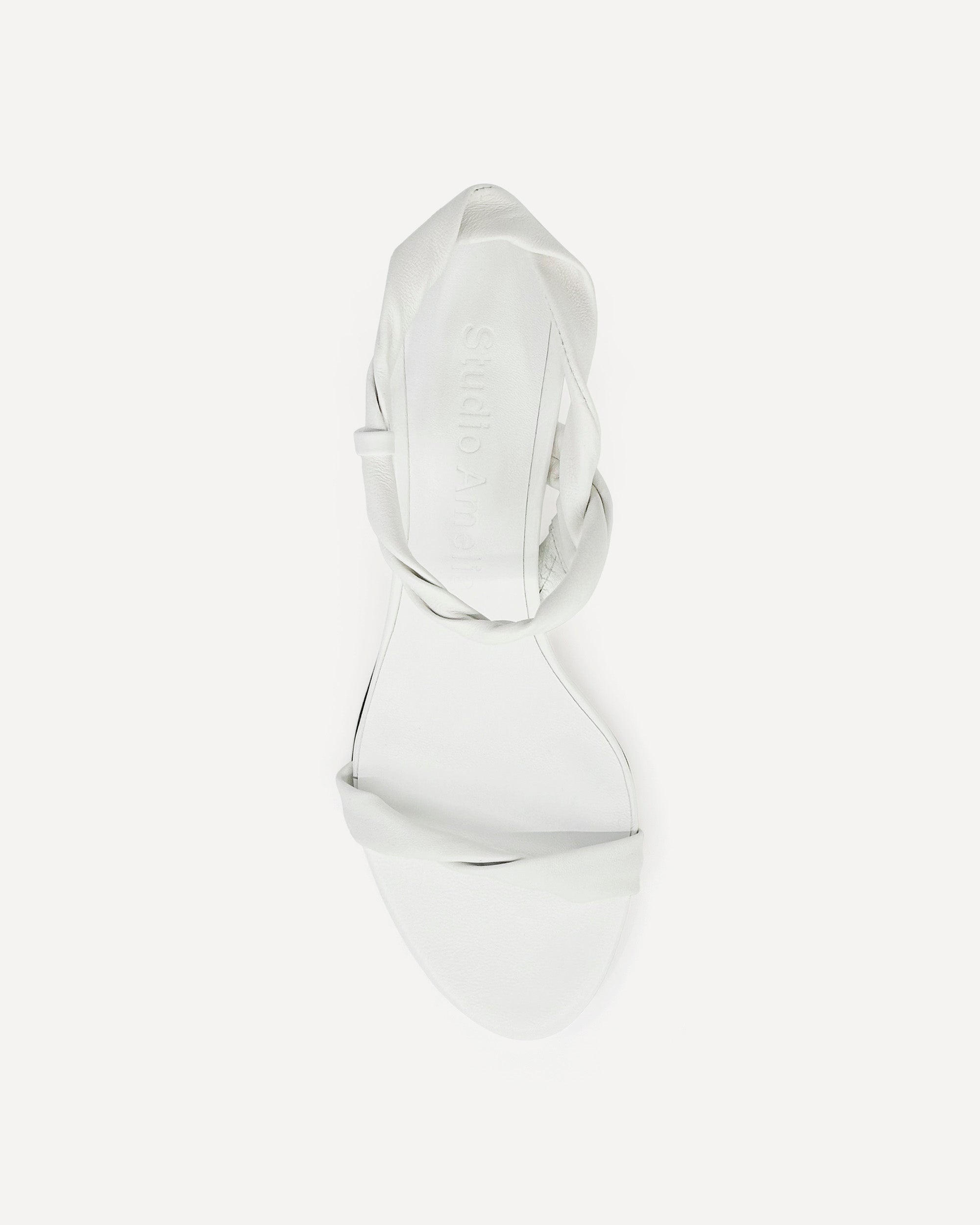 Top view of a white leather sandal with high heels