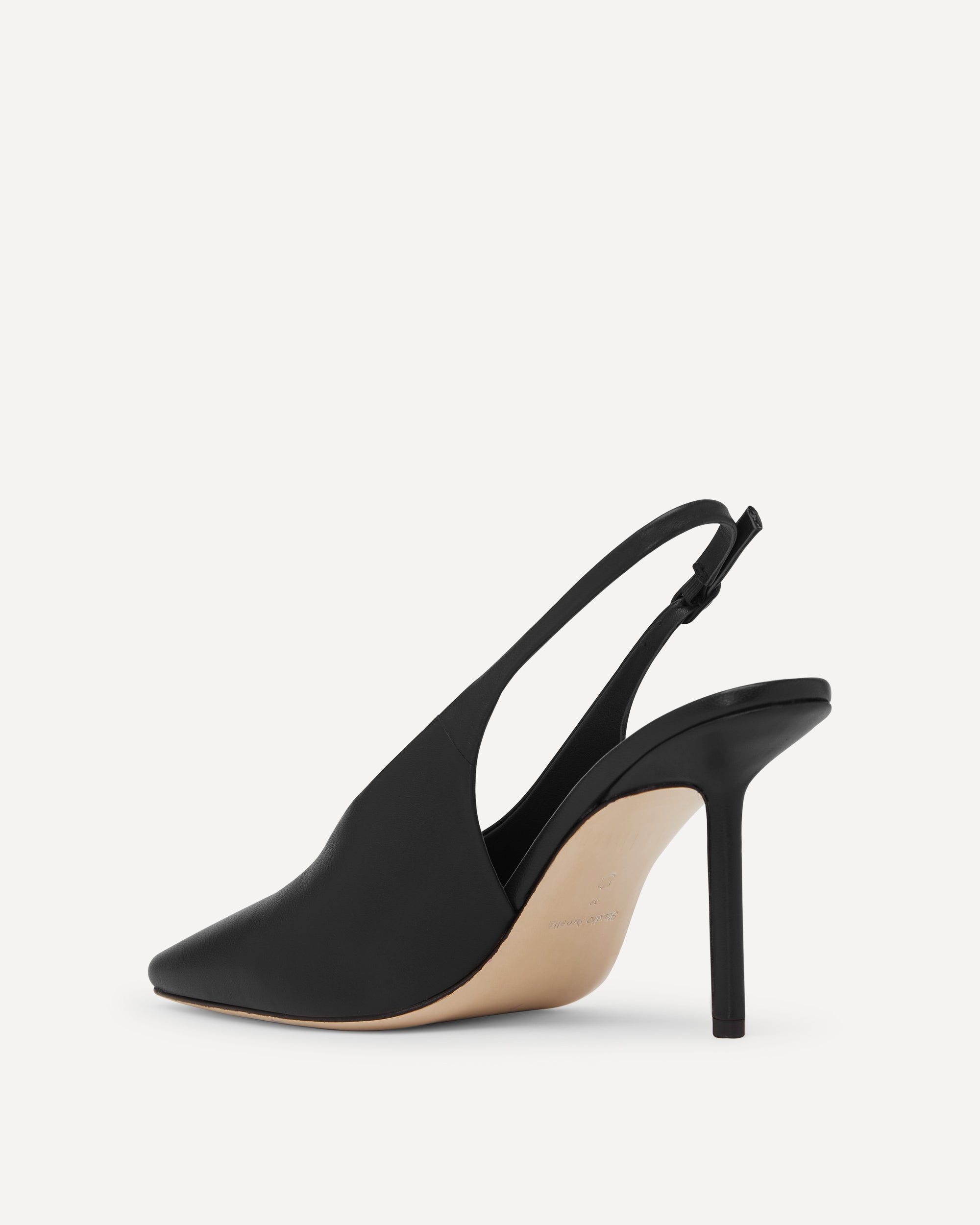 Black high-heeled slingback shoe on a white background