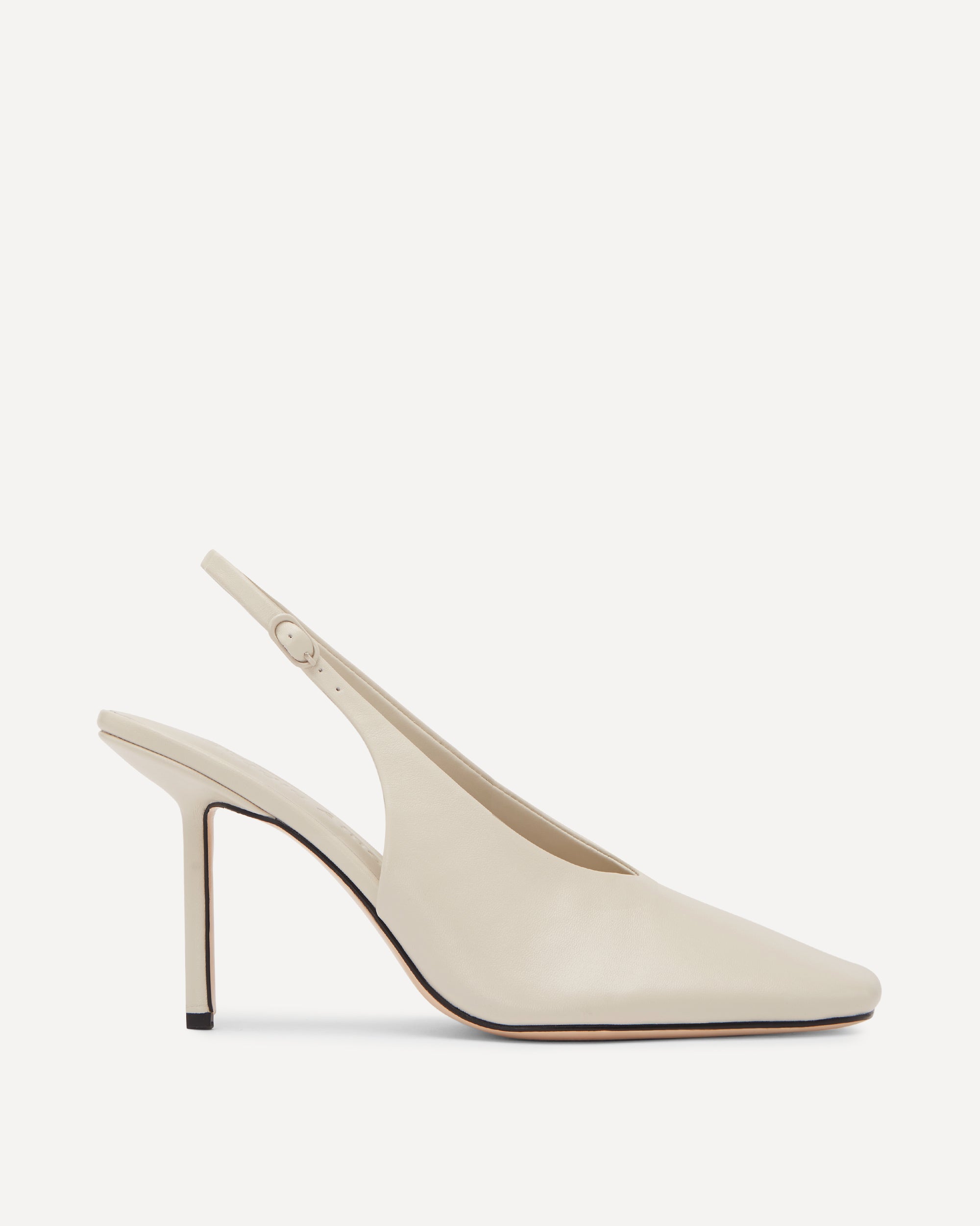 White high-heeled slingback shoes on a white background
