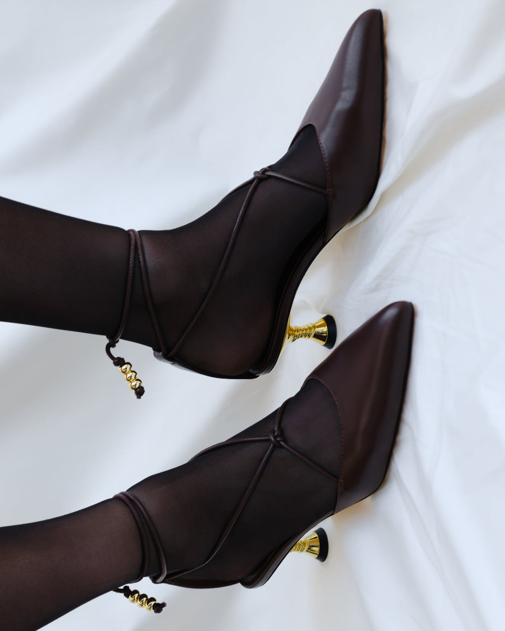 A pair of chocolate coloured kitten heels with gold details