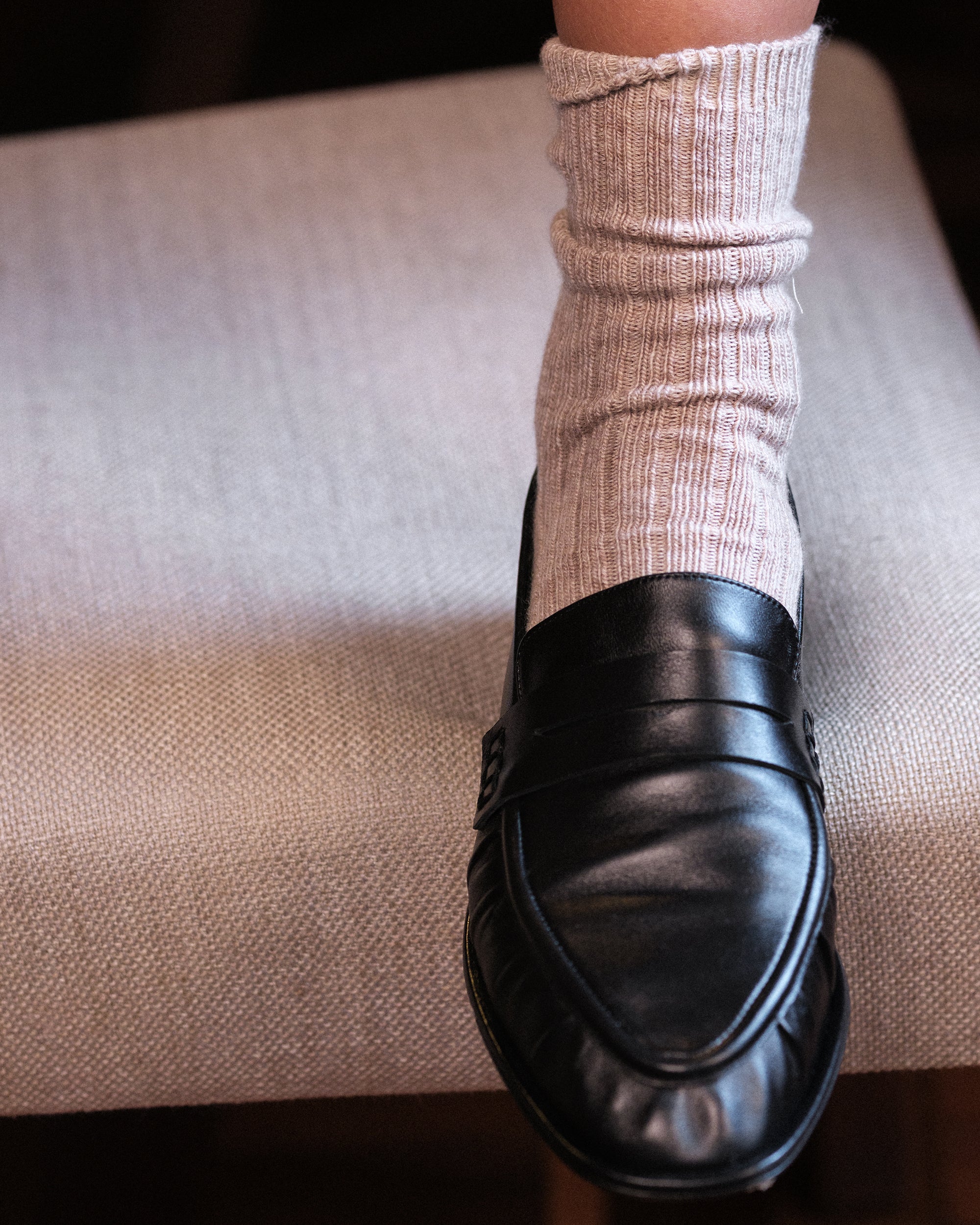 Black leather loafer worn with socks