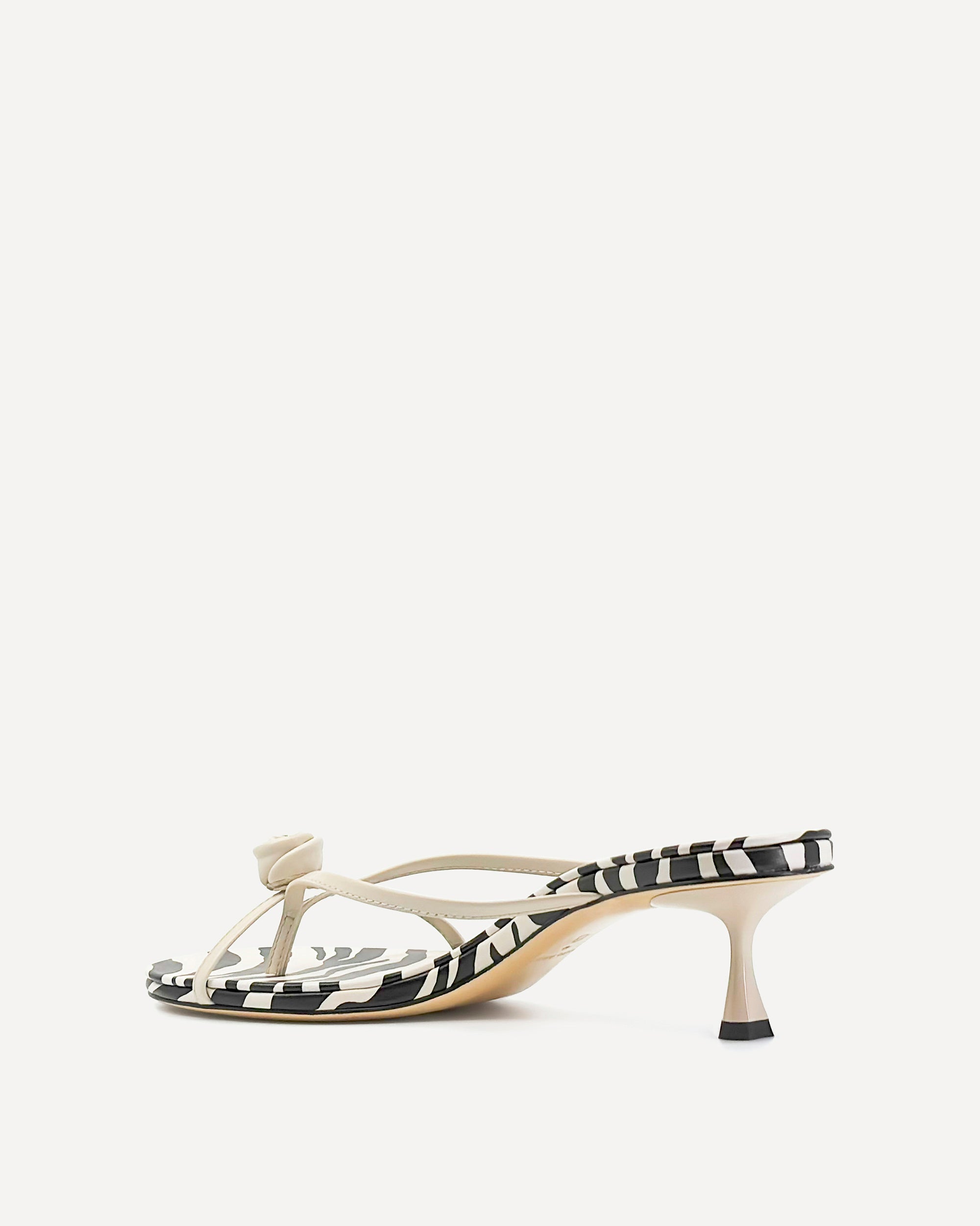 Zebra print sandal with a kitten heel on a white background