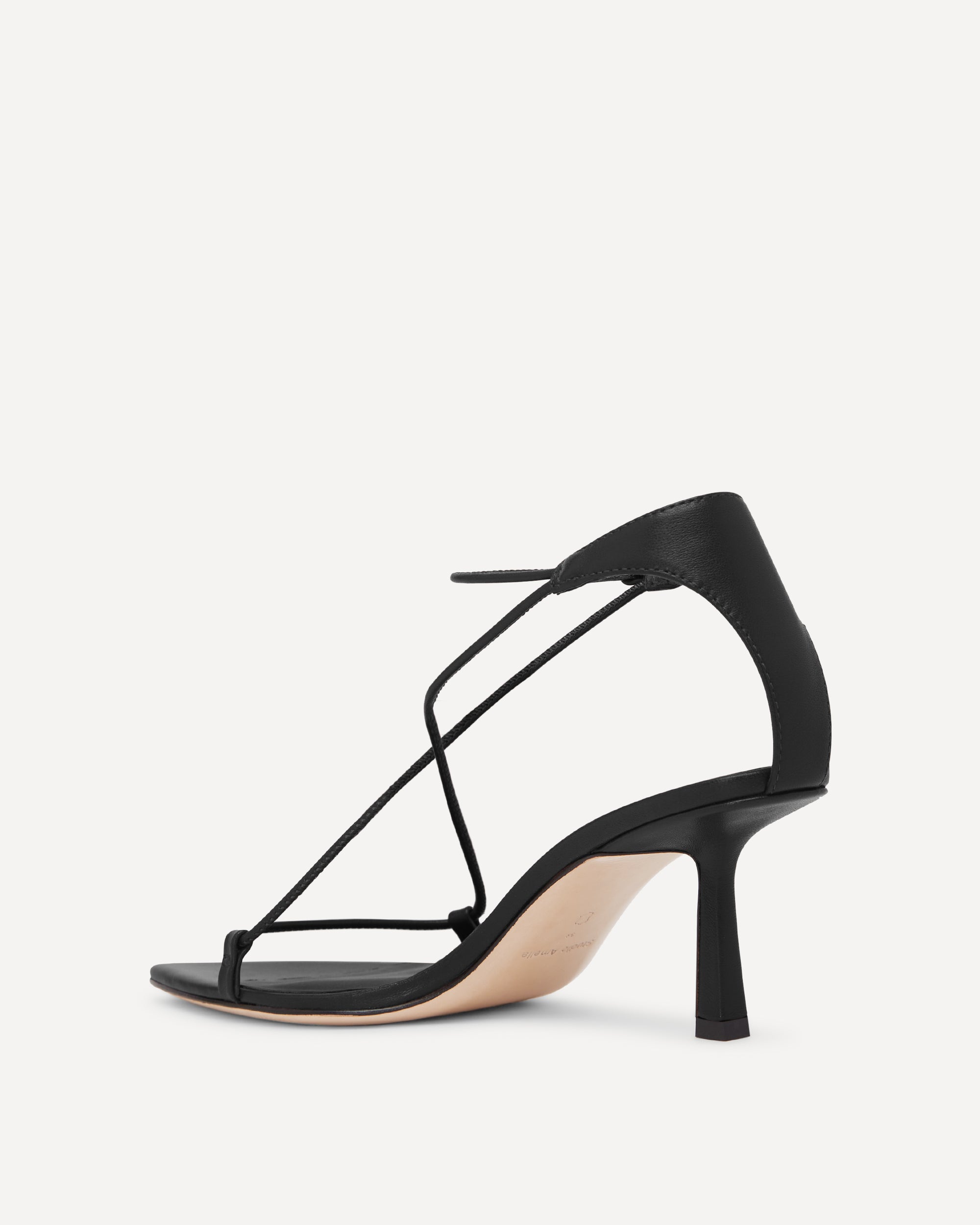 Black strappy high-heeled sandal on a white background