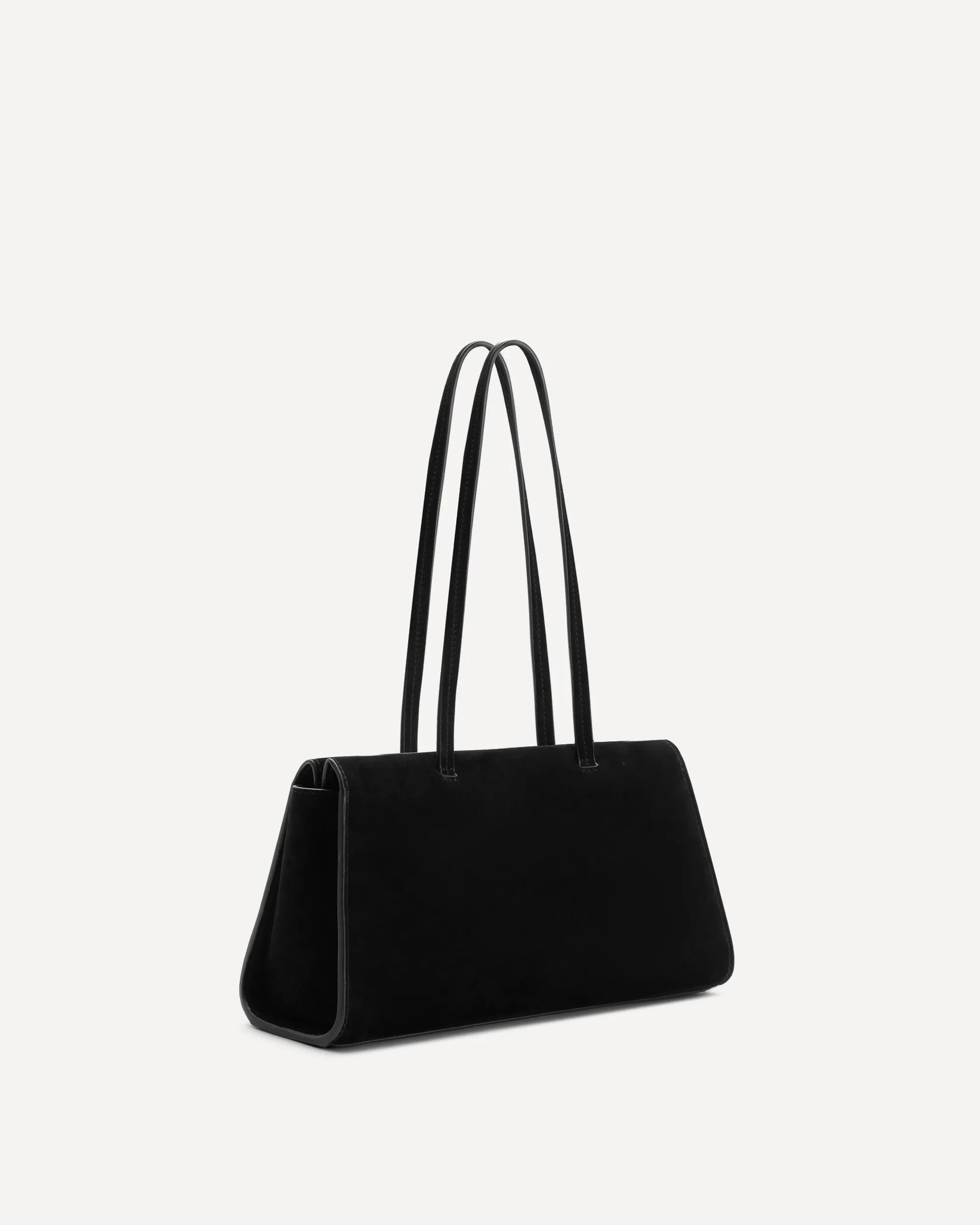 A black suede or velvet tote bag with long shoulder straps, shown from a side profile against a light gray background.
