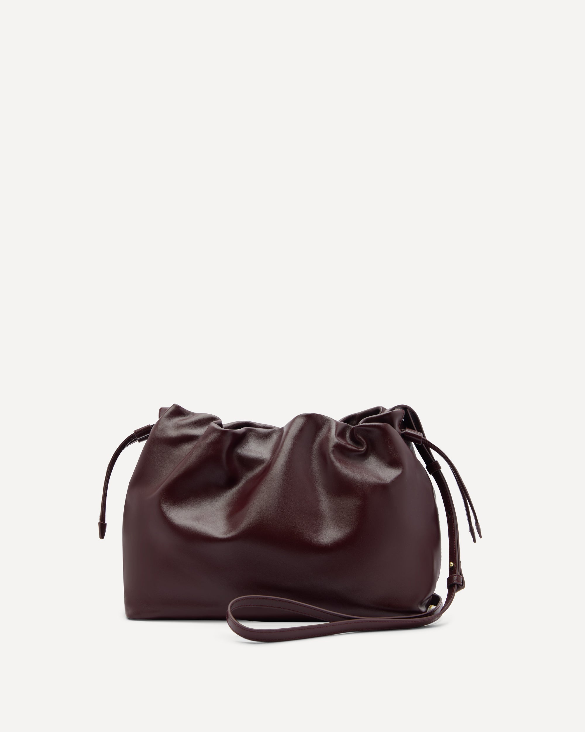Burgundy leather bag with drawstring and cross body strap