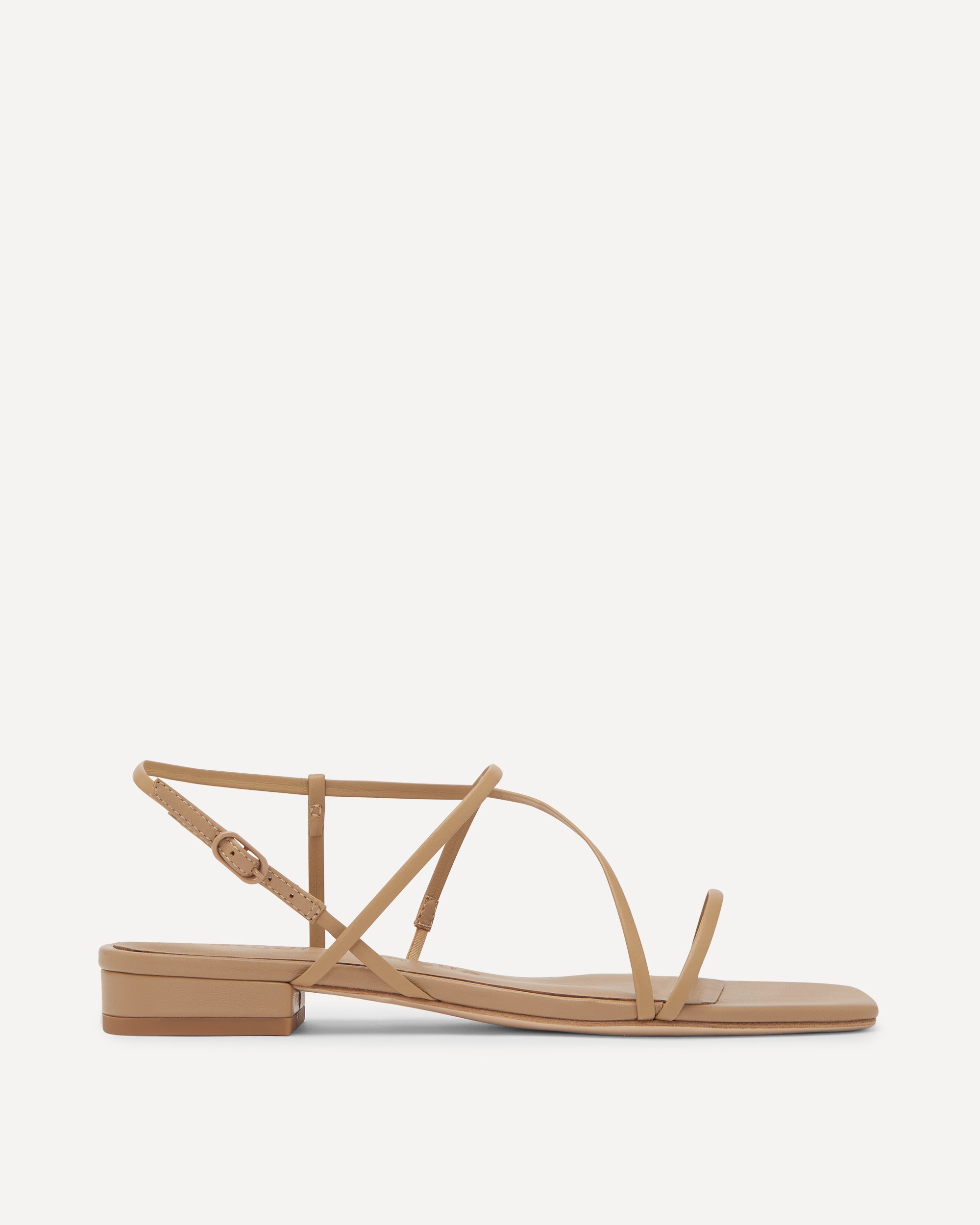 Tan sandal with thin straps on a white background
