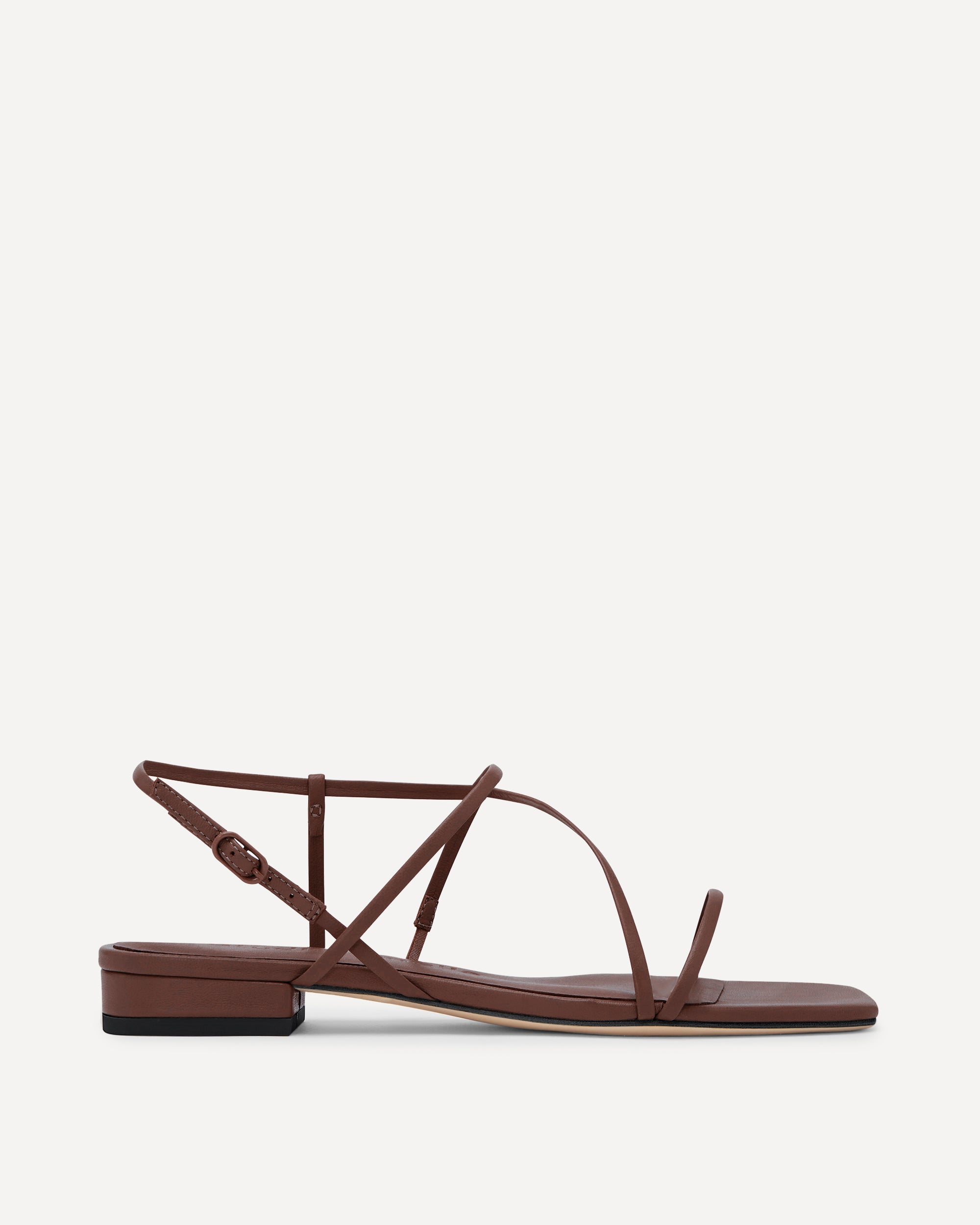 Brown sandal with thin straps on a white background