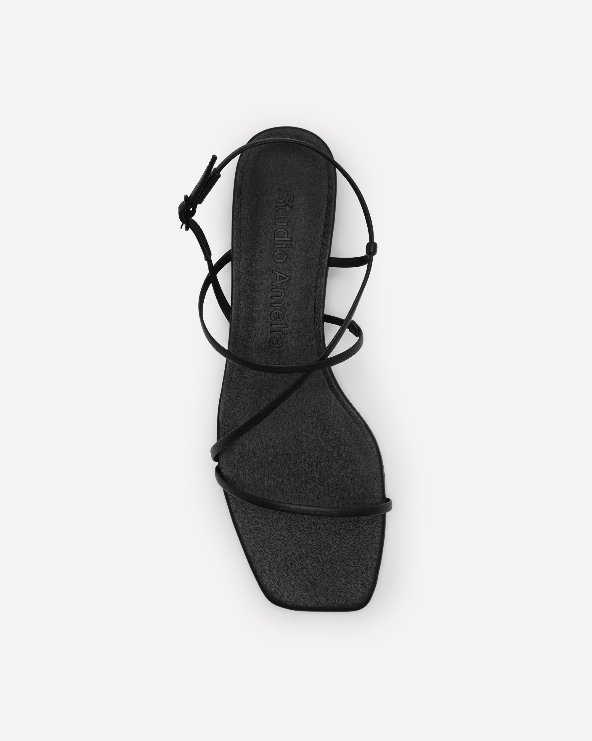Black strappy sandal on a white background
