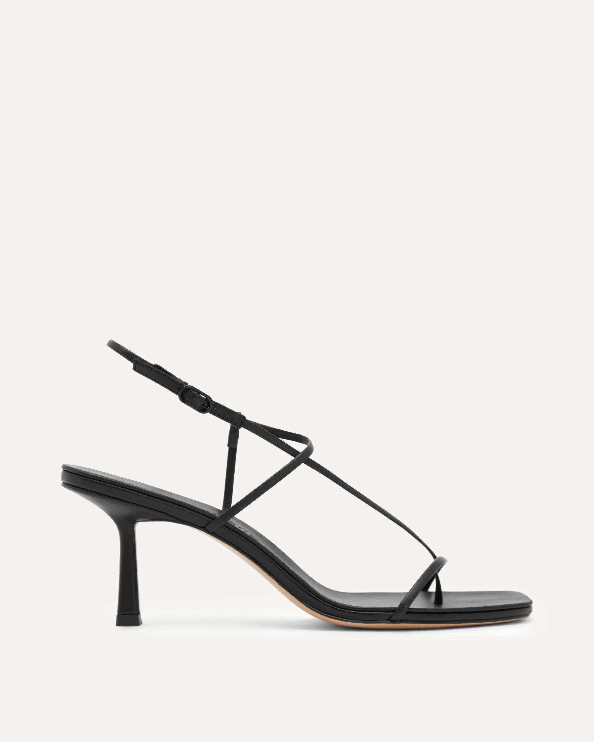 Black sandal with thin straps on a white background