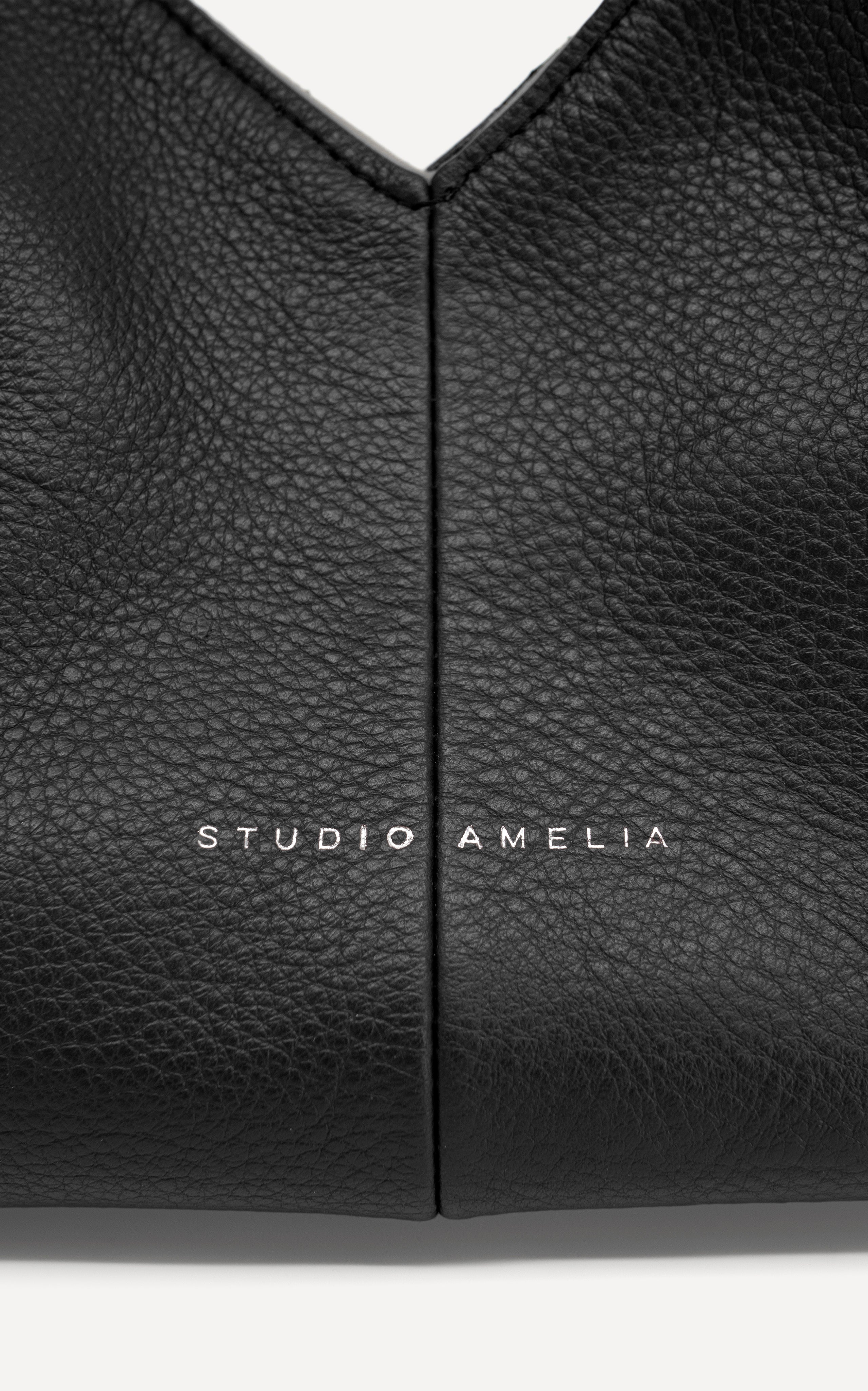 Studio Amelia's logo on a black leather handbag