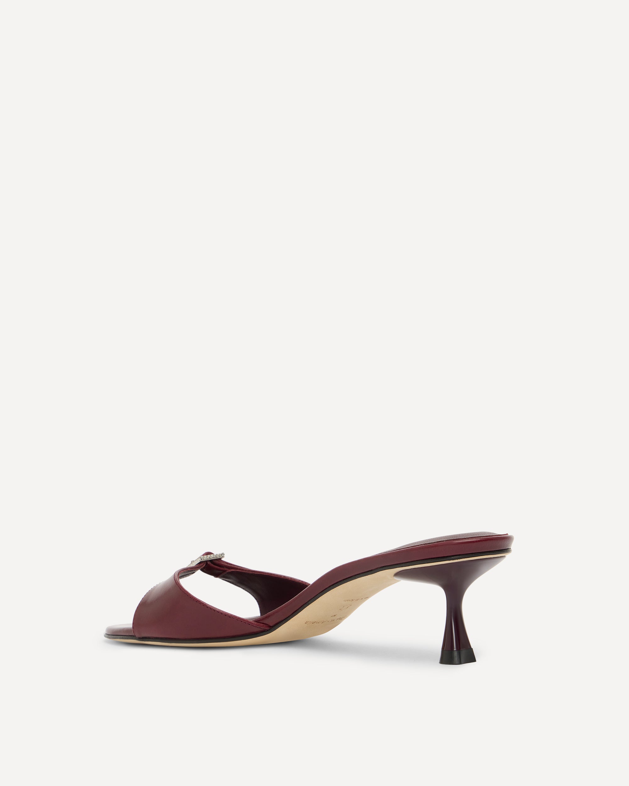Burgundy leather kitten heel on a white background