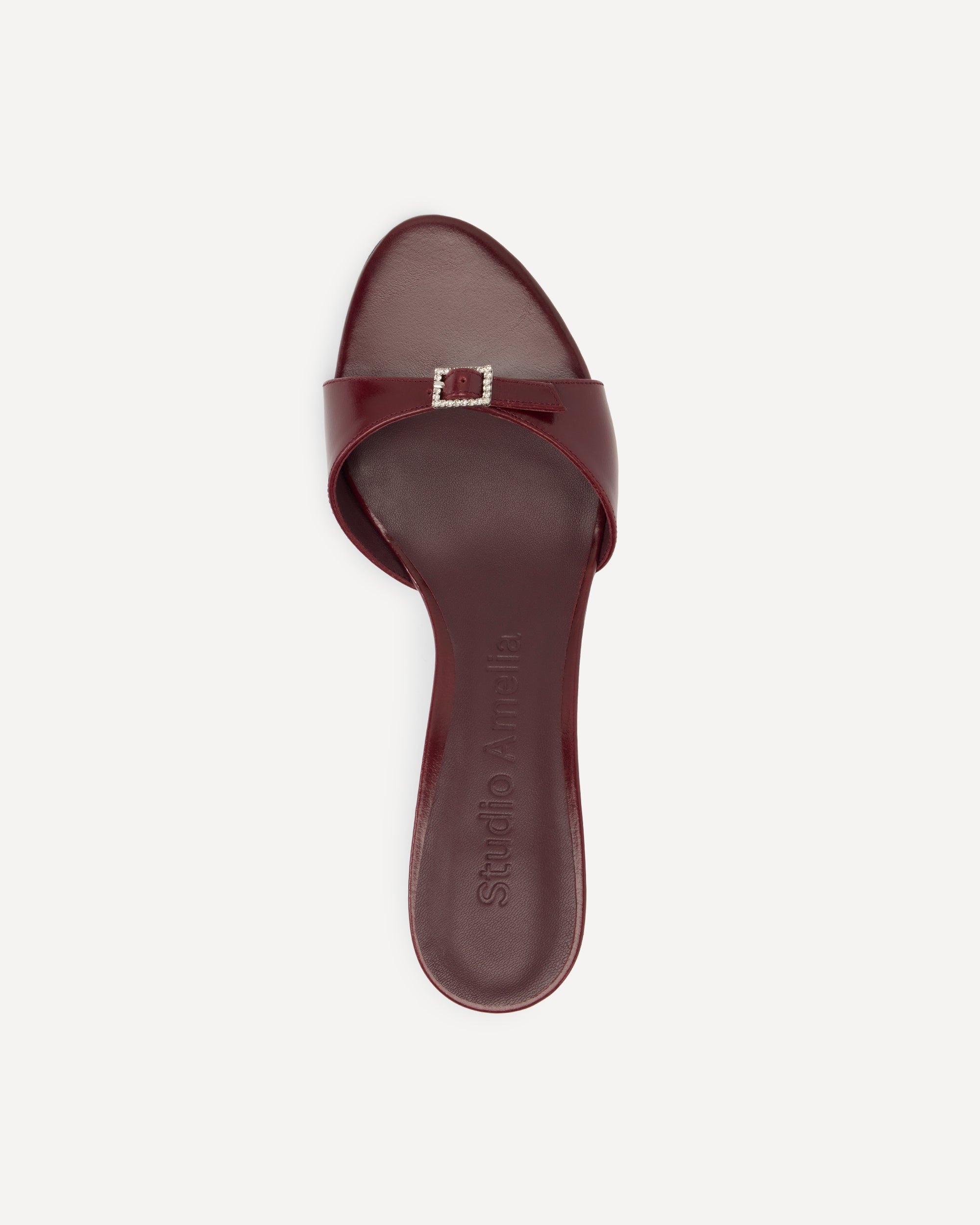 Maroon sandal with buckle on a white background