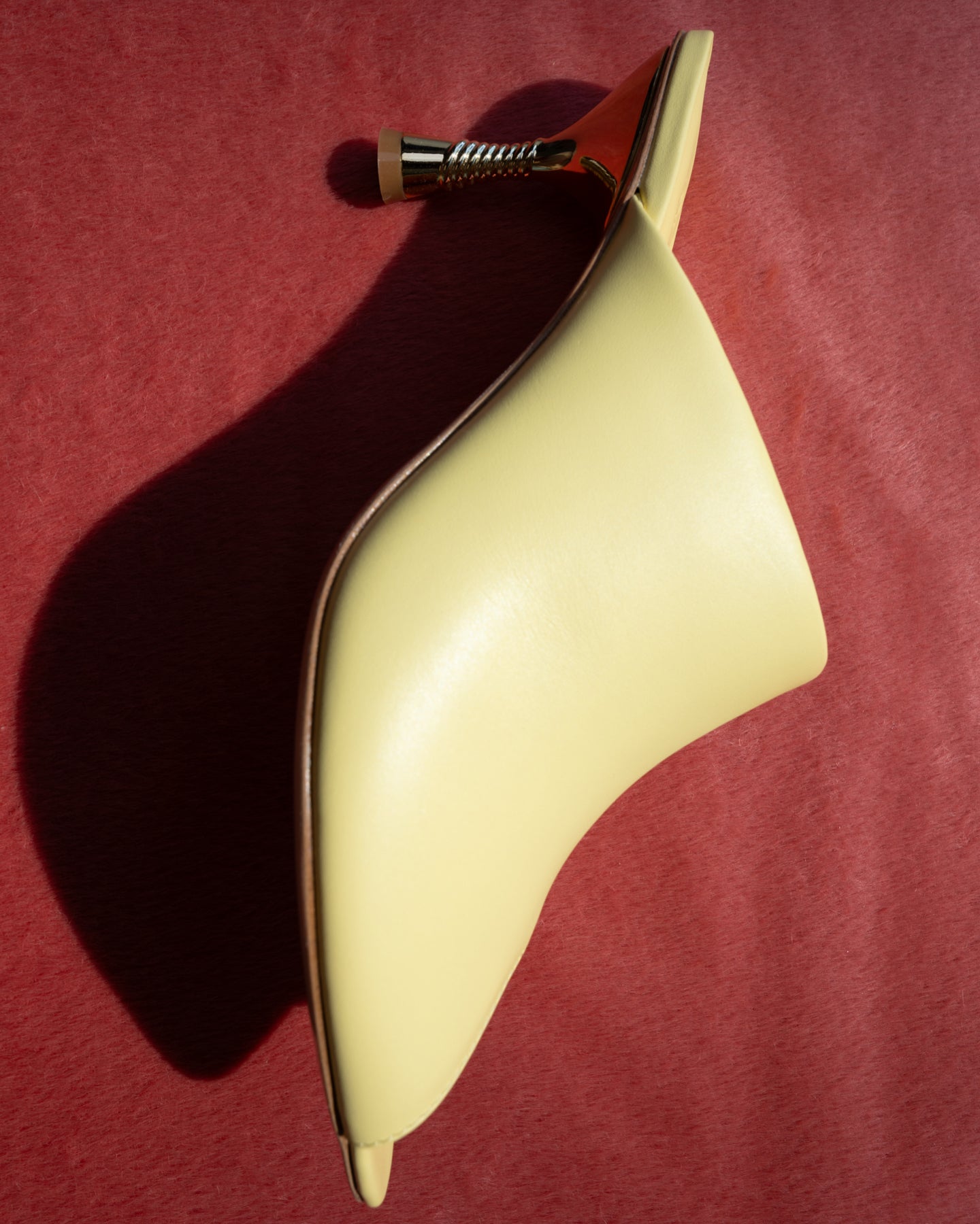 A yellow leather mule by Studio Amelia