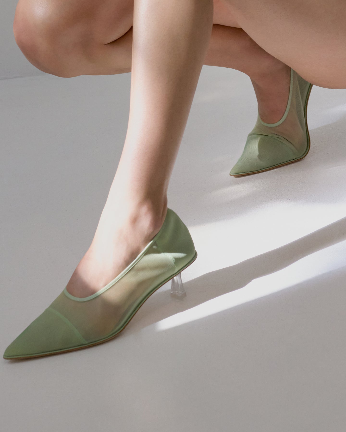 A pointed green mesh pump by Studio Amelia