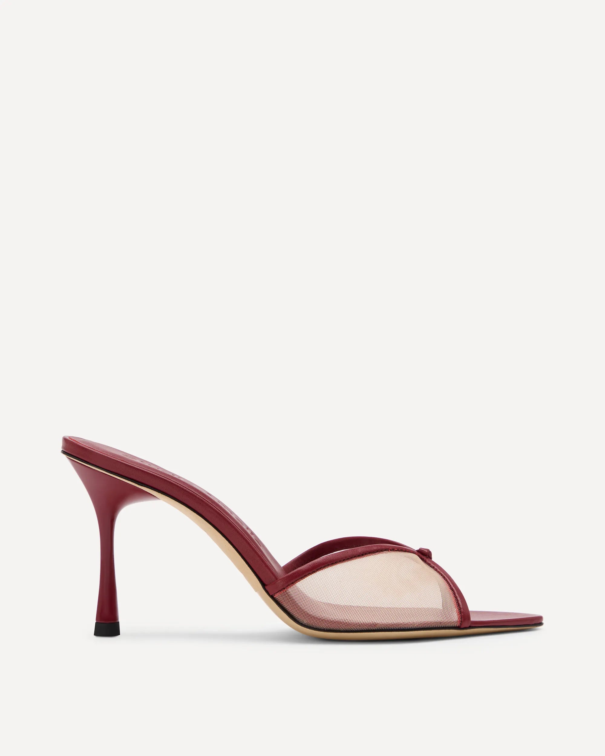 Red high-heeled sandal with straps on white background