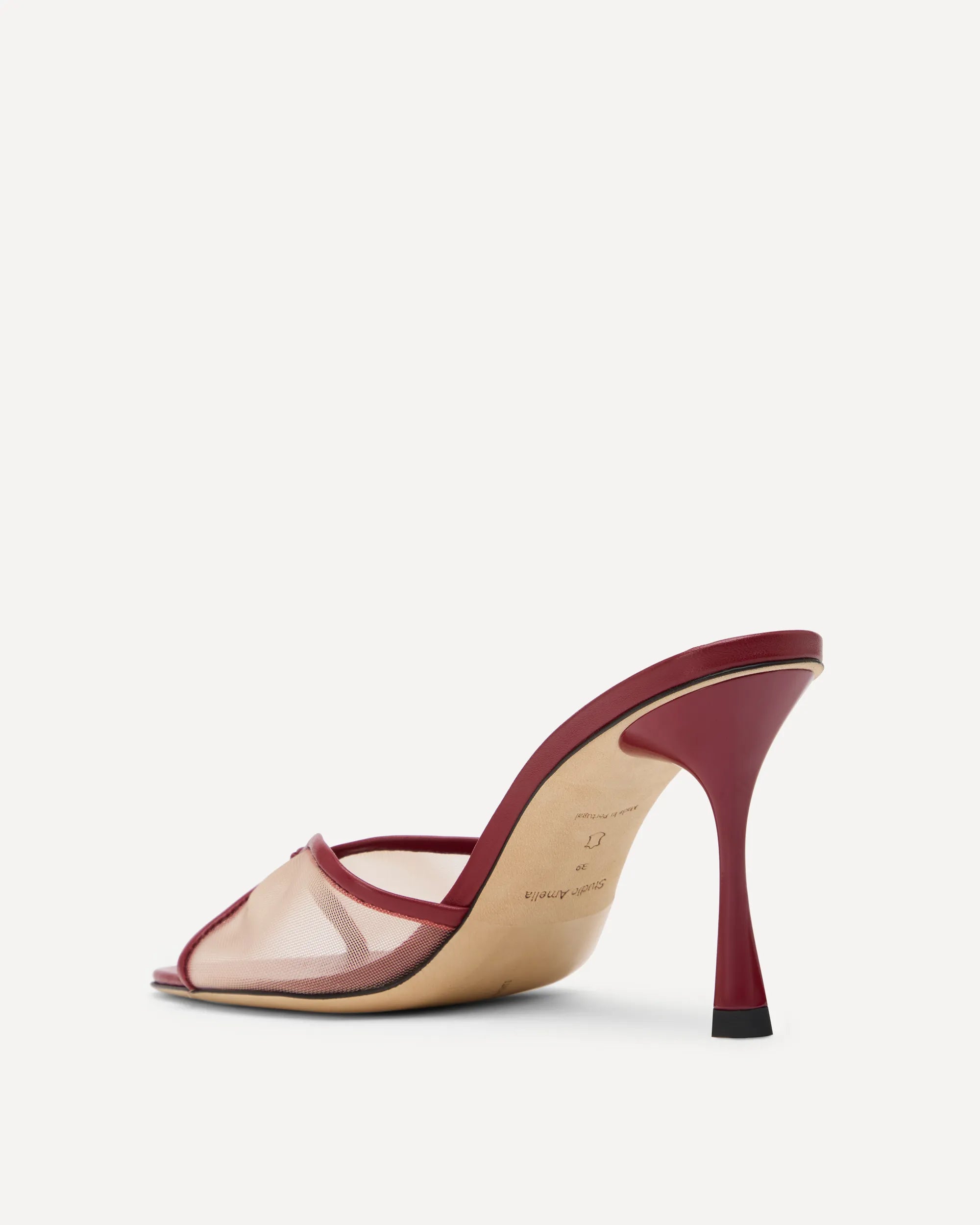 A red high heeled sandal with mesh upper