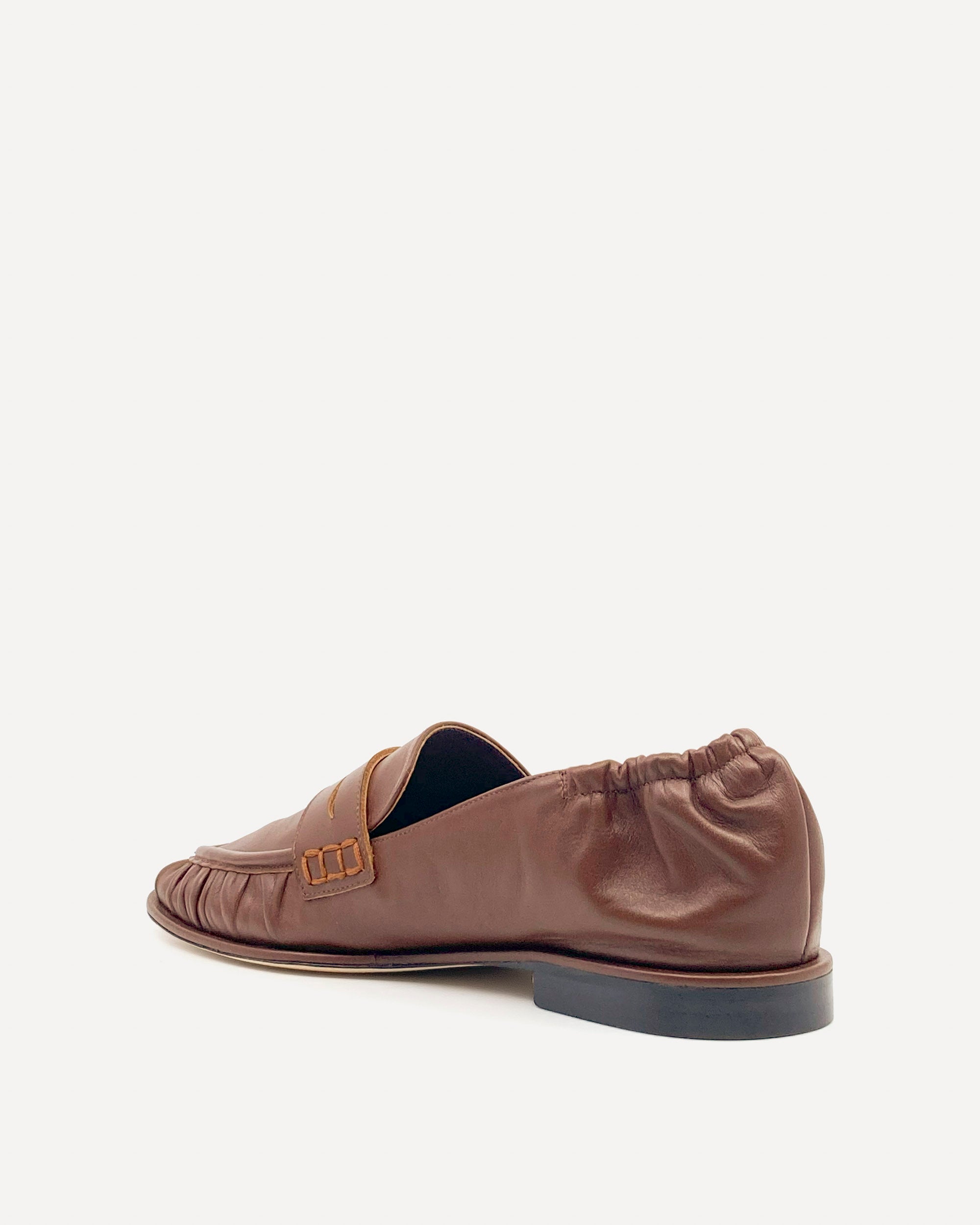 Brown loafer shoe on a white background