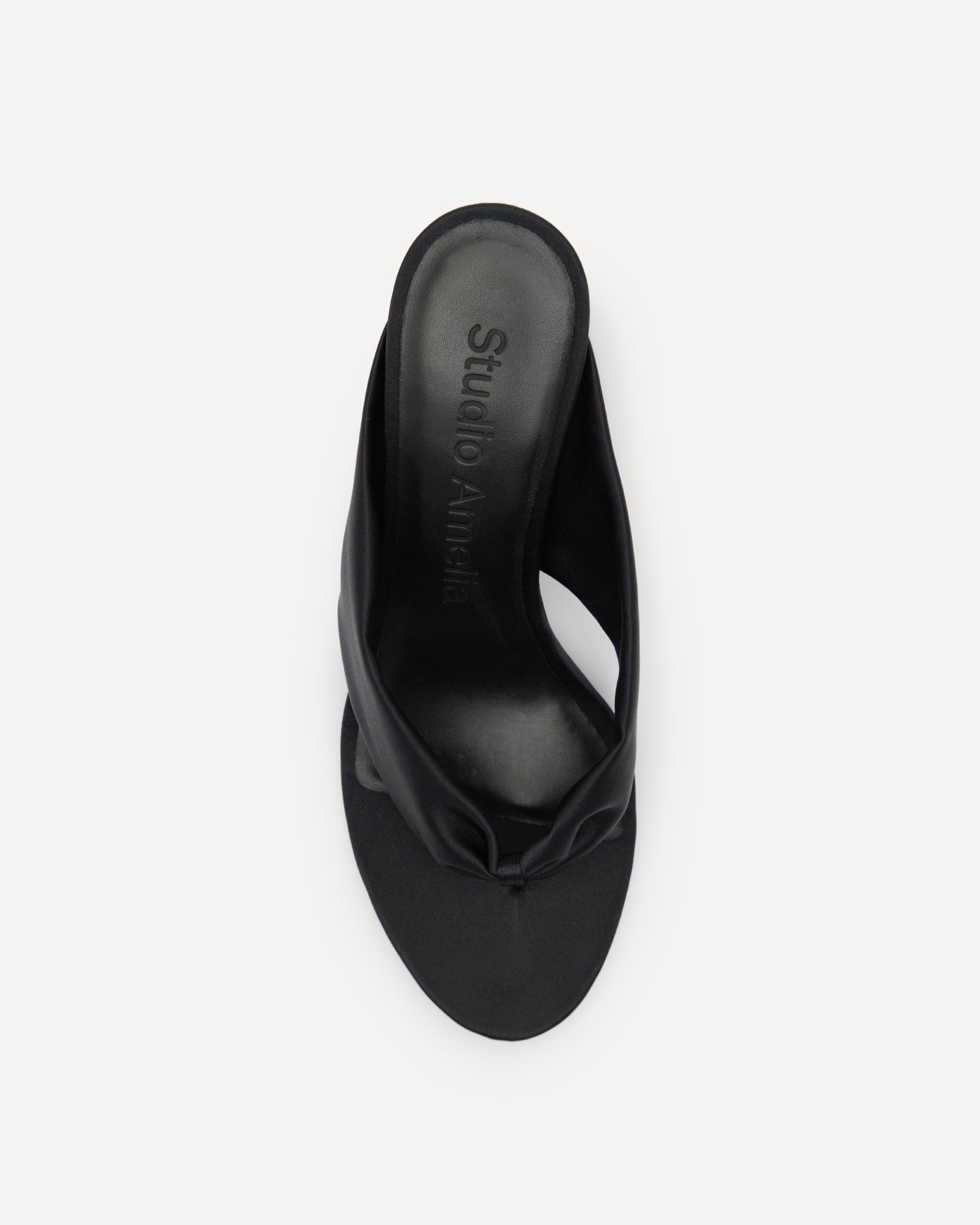 A black silk flip flop sandal with a medium heel