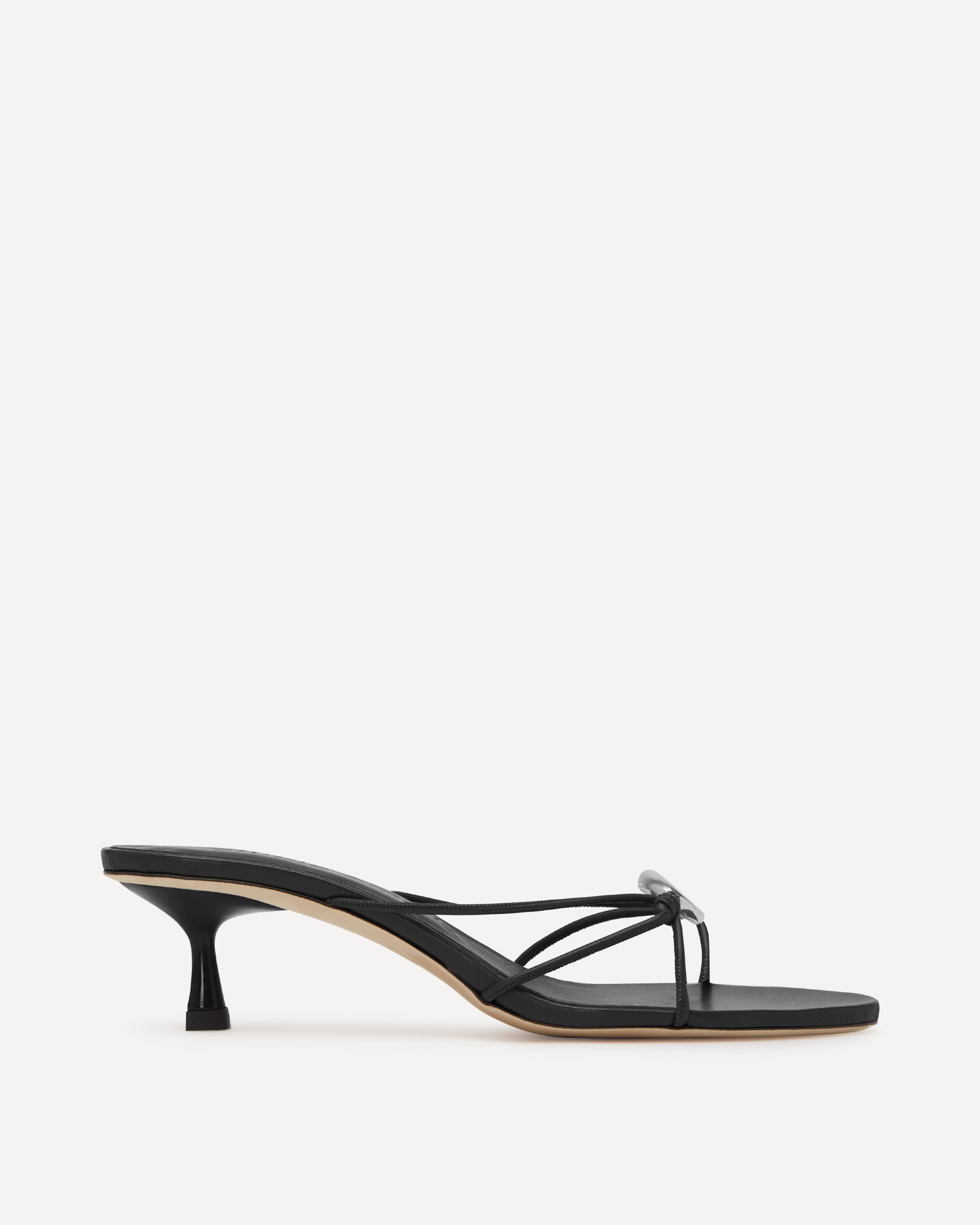 Black sandal with thin strap on a white background