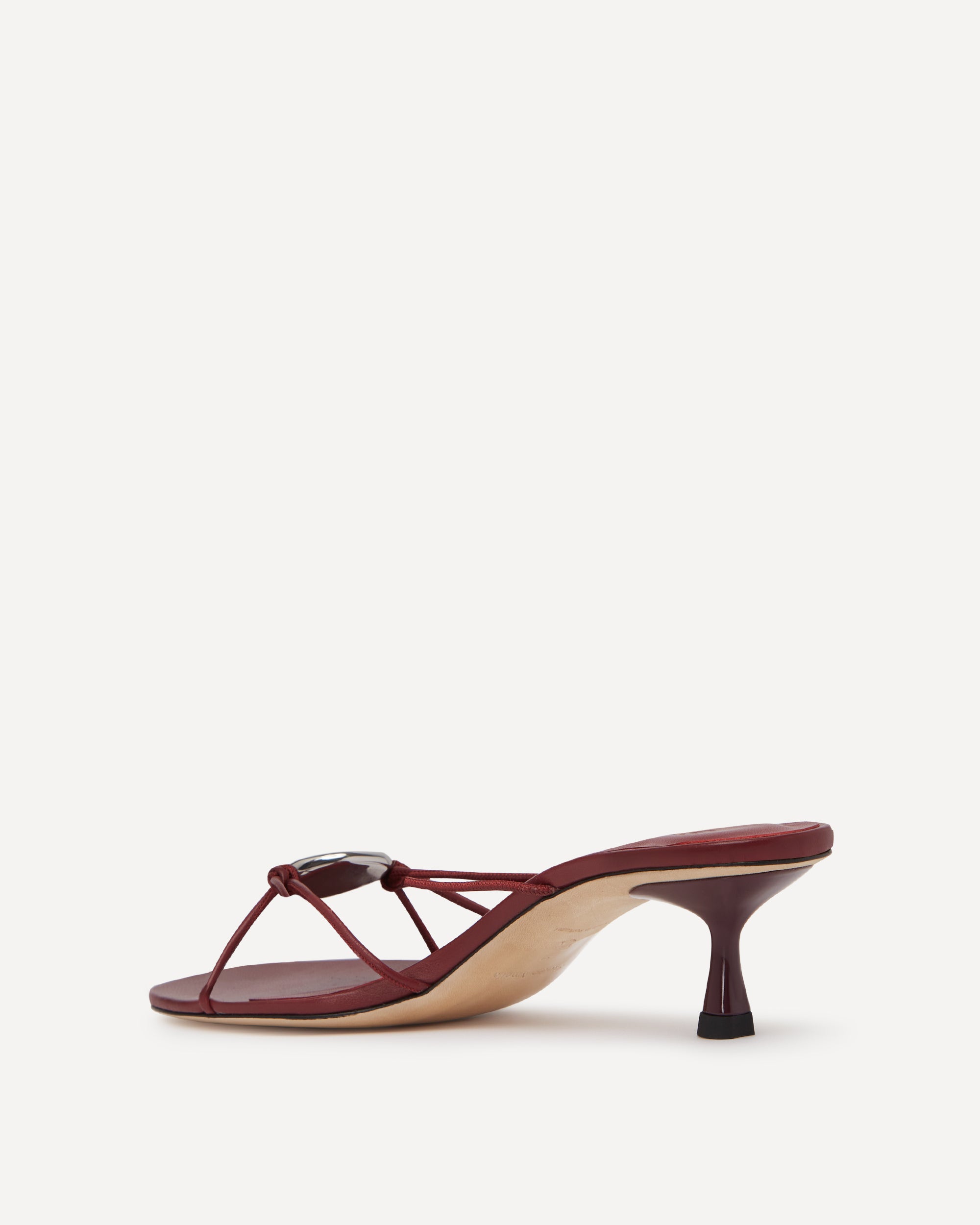 A burgundy leather sandal with straps and a short heel