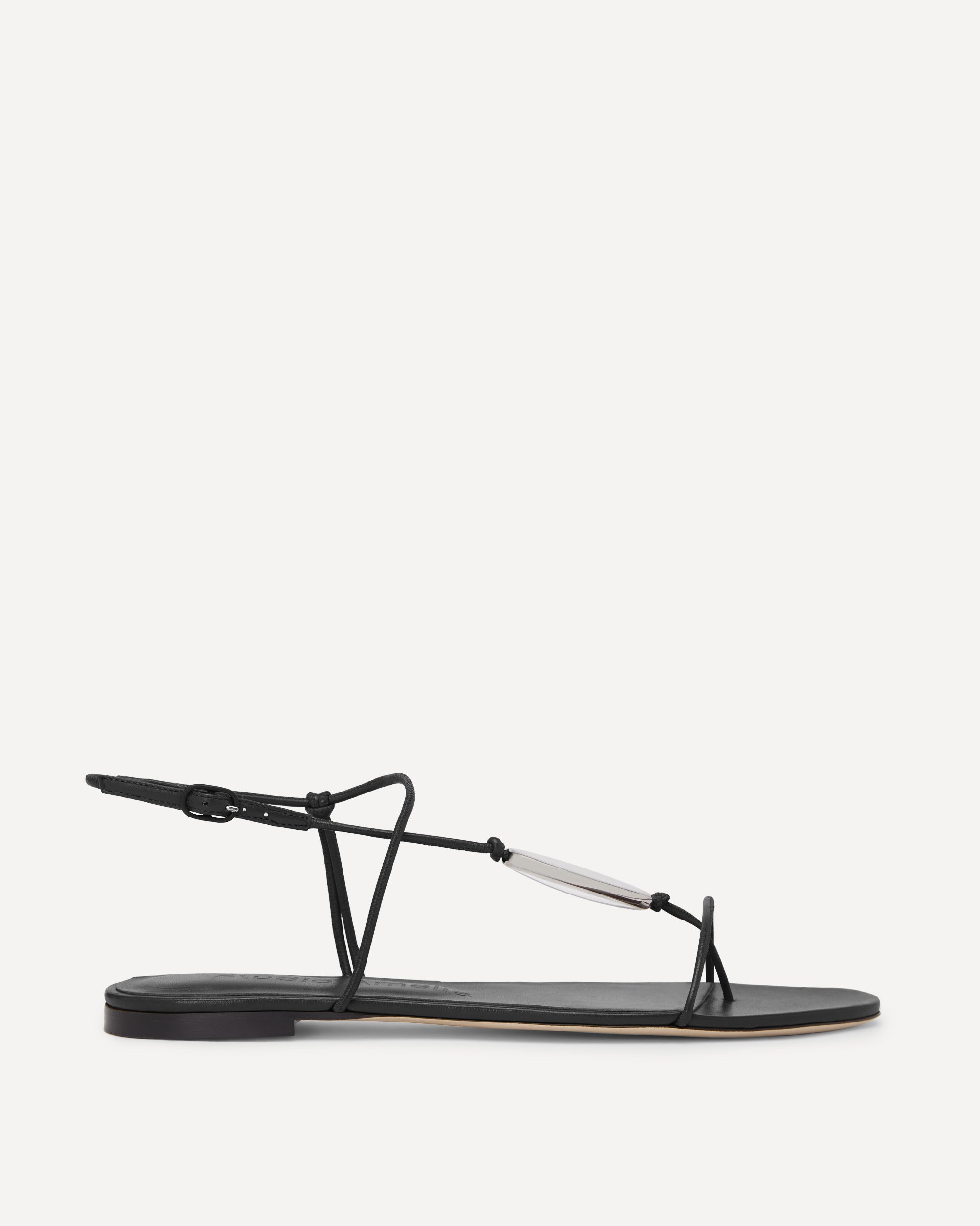 Black leather flat sandal with thin straps on a white background