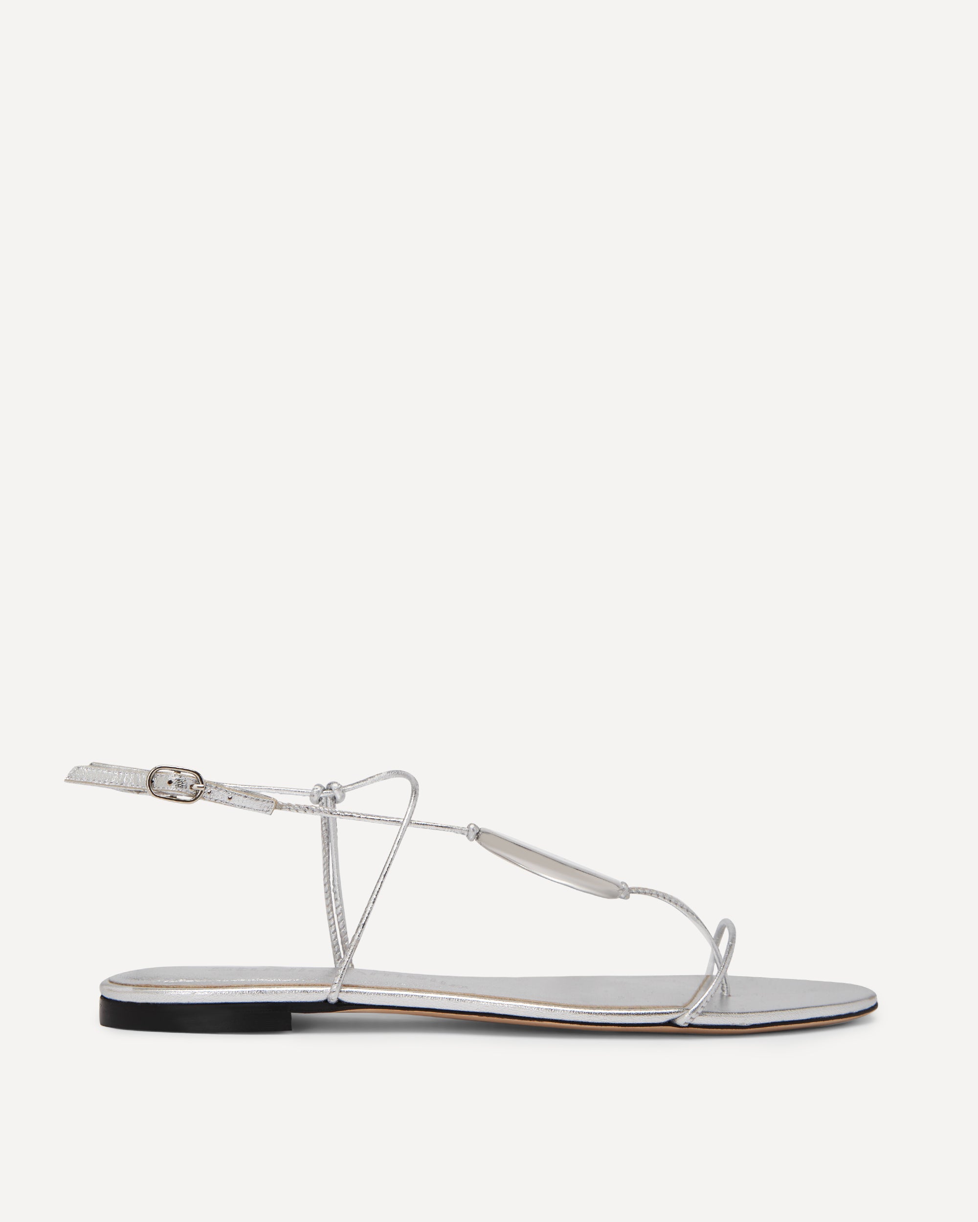 Silver sandal with a thin strap on a white background