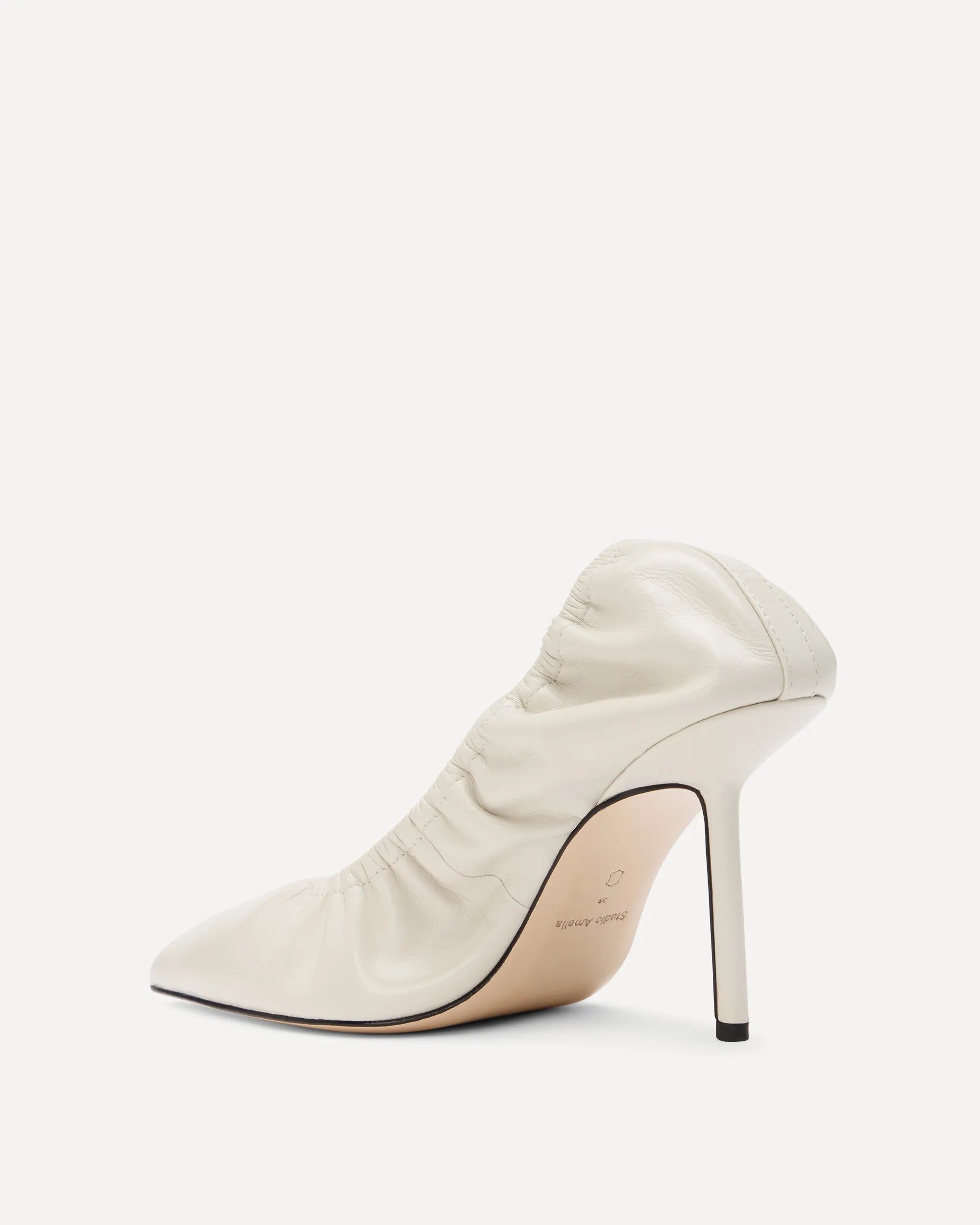 A white leather pump with a high heel