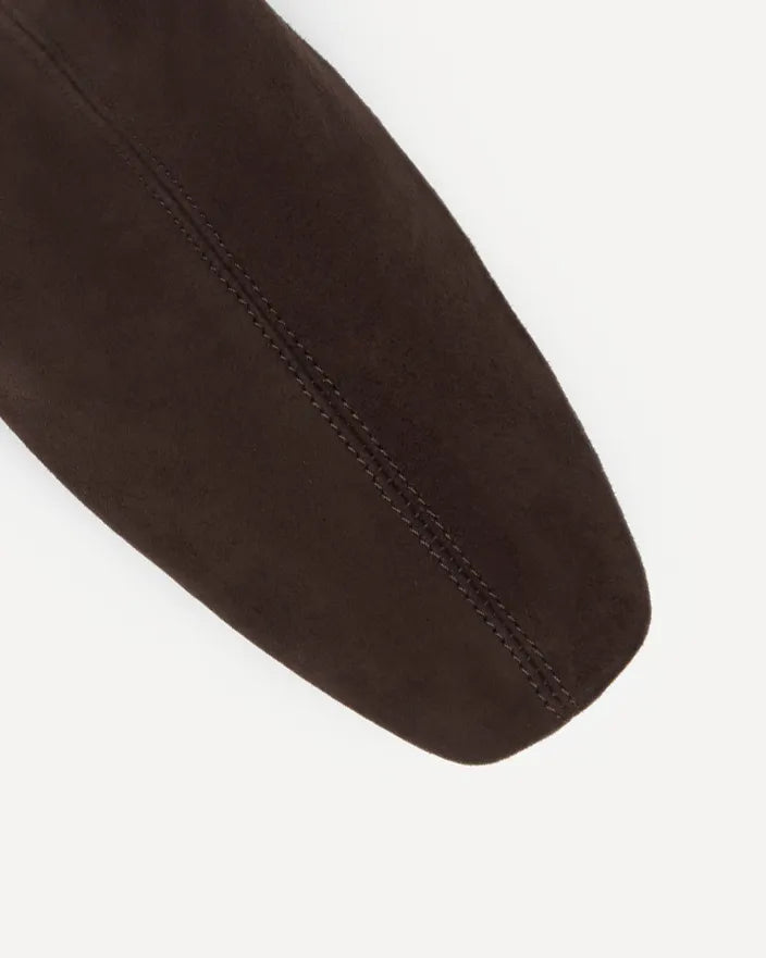 A close up of a dark brown suede boot with a square toe shape