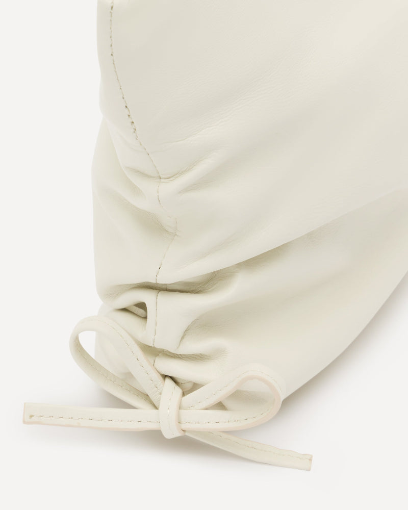 Close-up of a white leather womens clutch