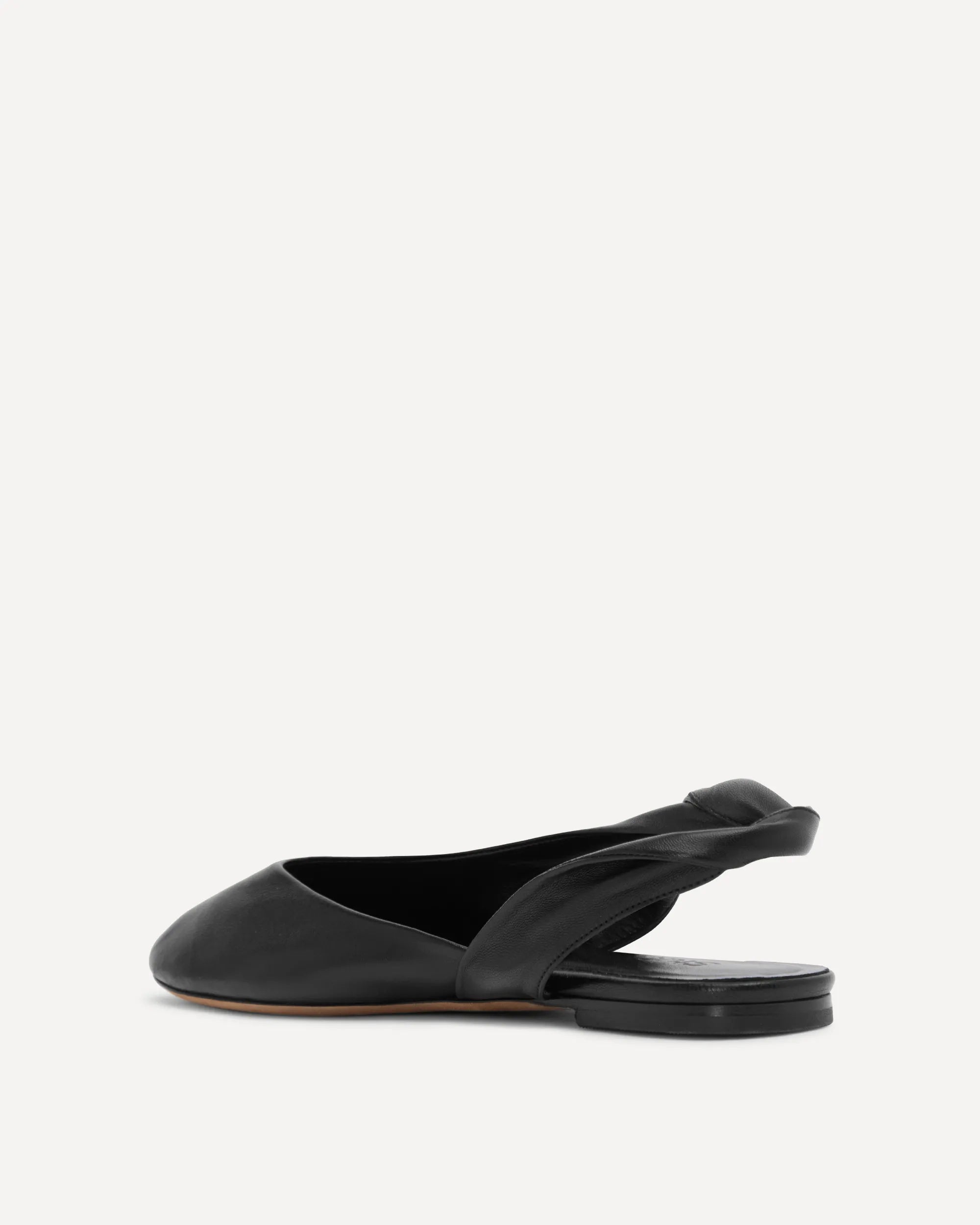 A single black leather slingback flat shoe shown from a side profile view against a plain light gray background.