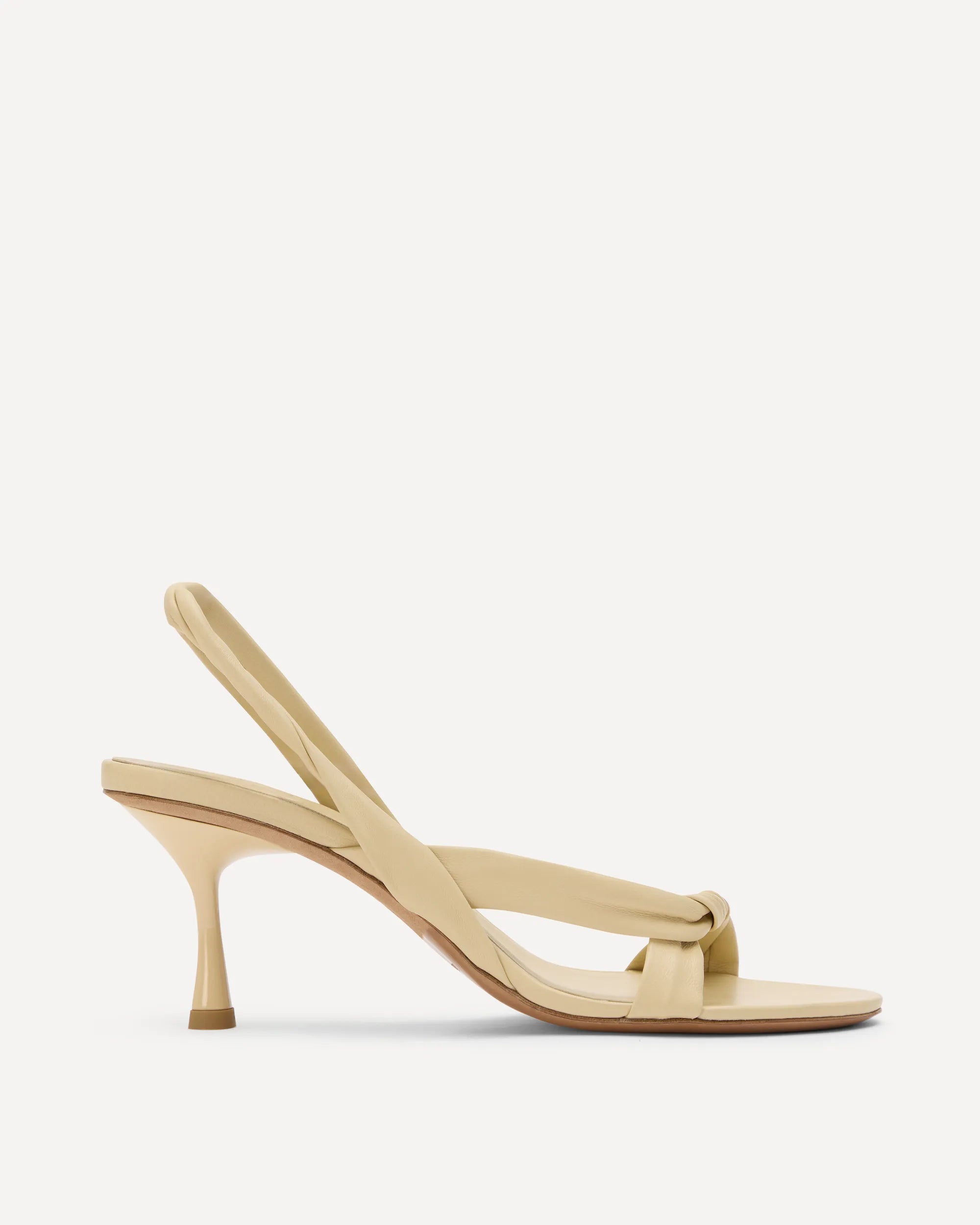 Beige high-heeled sandal on a light beige background