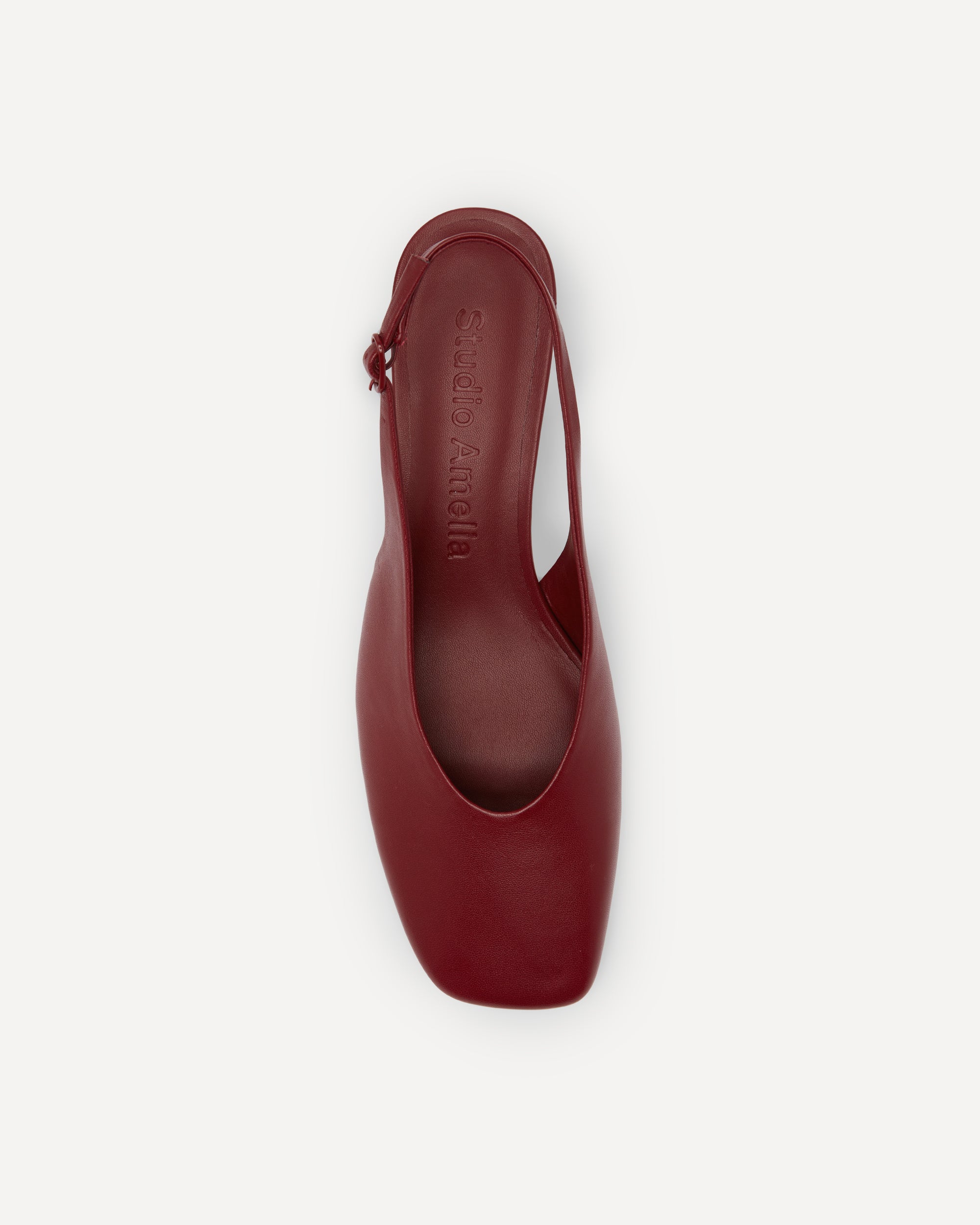 A maroon coloured leather pump on a short heel