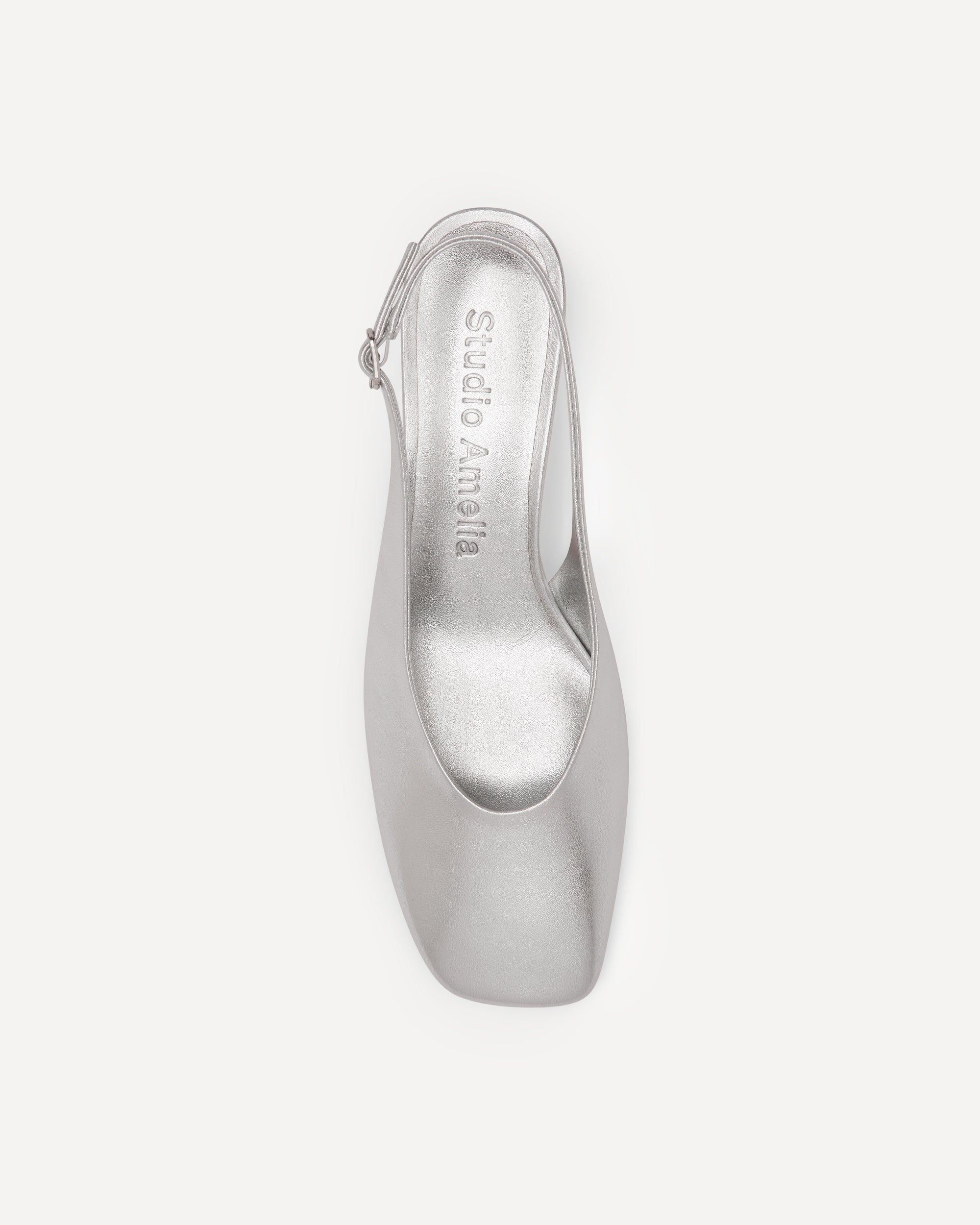Silver high-heeled shoe on a white background