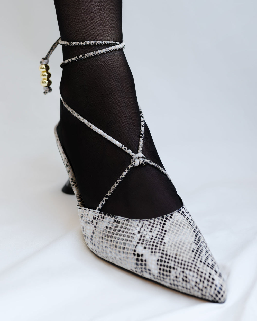 Snakeskin-patterned high-heeled shoes with criss-cross ankle straps