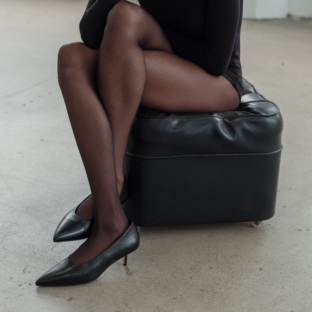 A pair of black leather kitten heel pumps