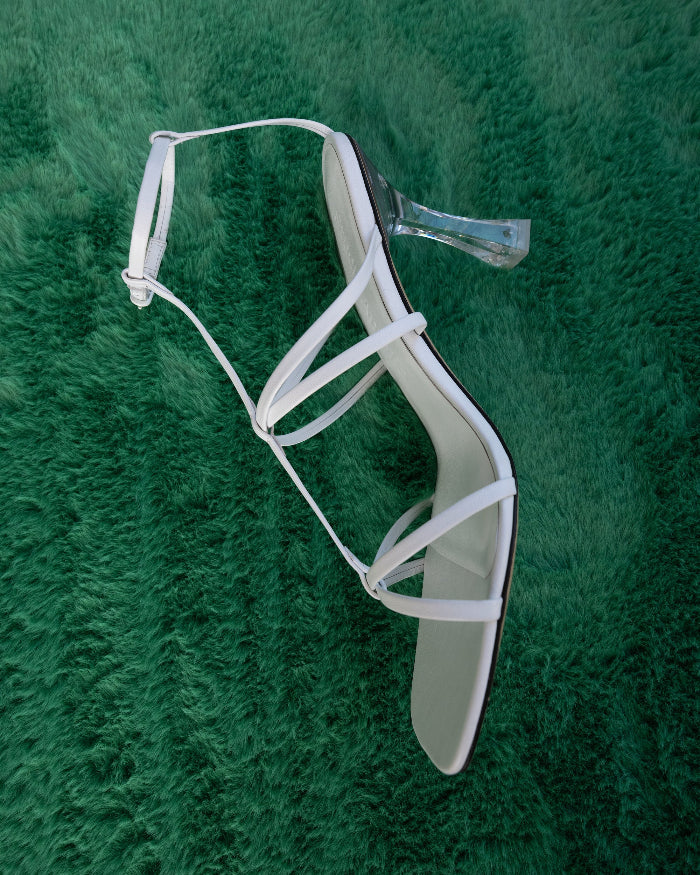 A white strappy open toe sandal with high heel