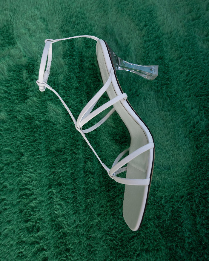 A white strappy open toe sandal with high heel