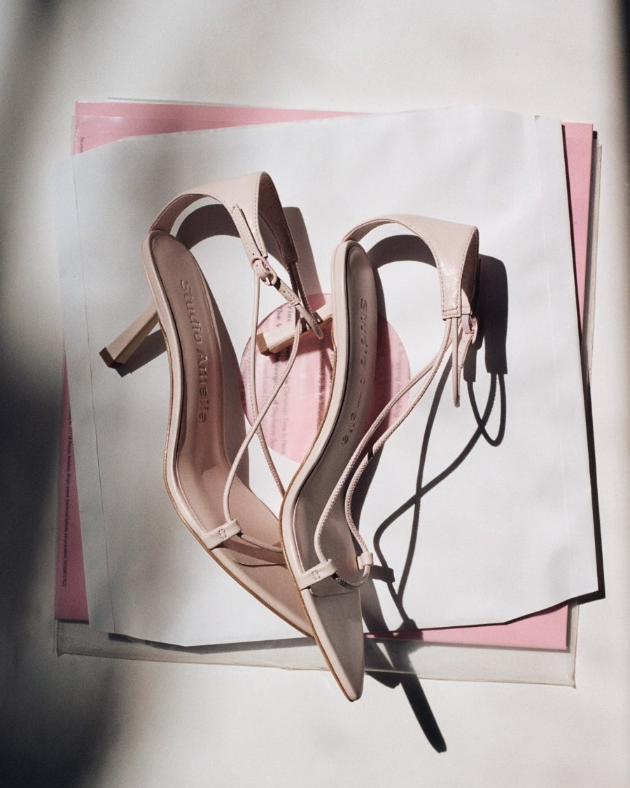 A pair of pink coloured high heels with straps