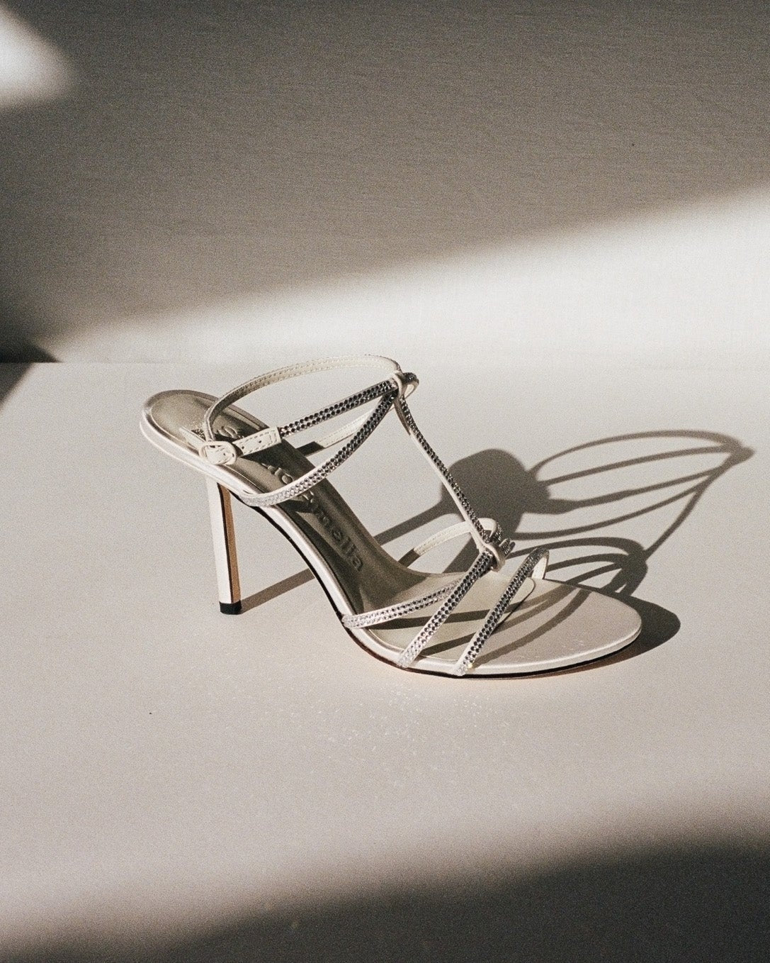 A white silk strappy sandal with diamante straps
